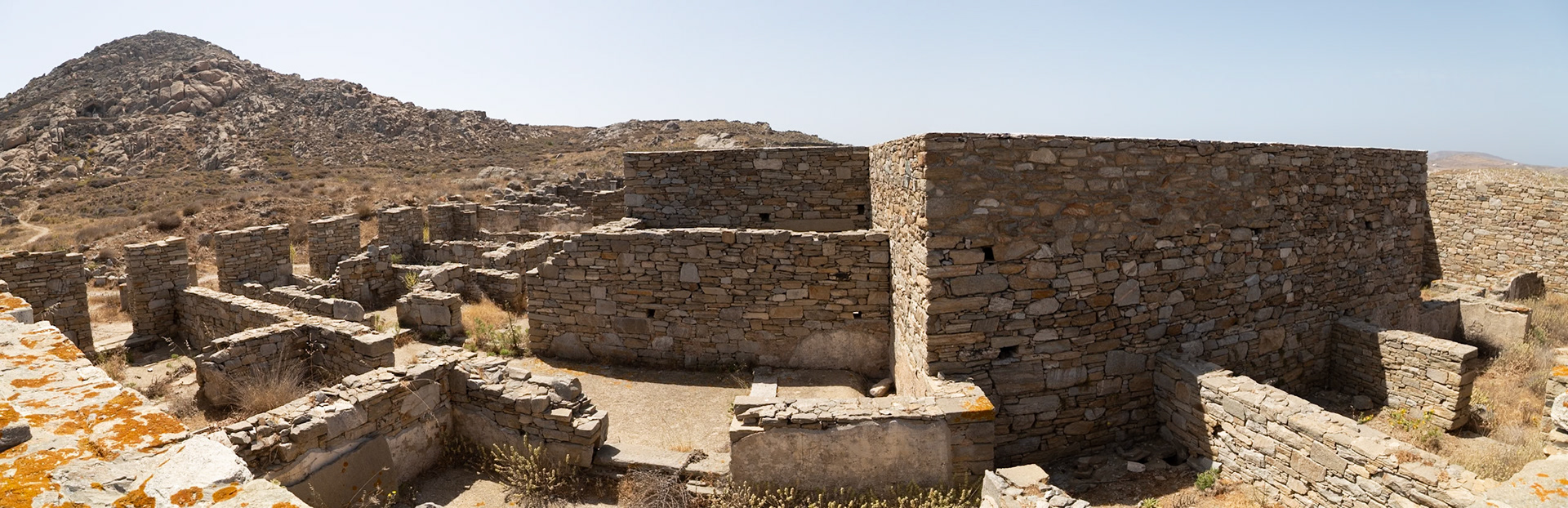 Delos, Greece - May 22nd 2018: Ruins of ancient stone buildings stand on Delos, a Greek island and archaeological site. These structures offer a glimpse into the island's rich history.