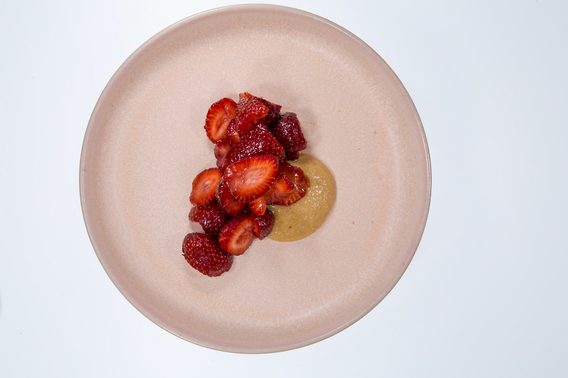 Fog Lark, Portland, Oregon - April 6th 2018: A plate with sliced strawberries and a dollop of sauce, showcasing a culinary creation.