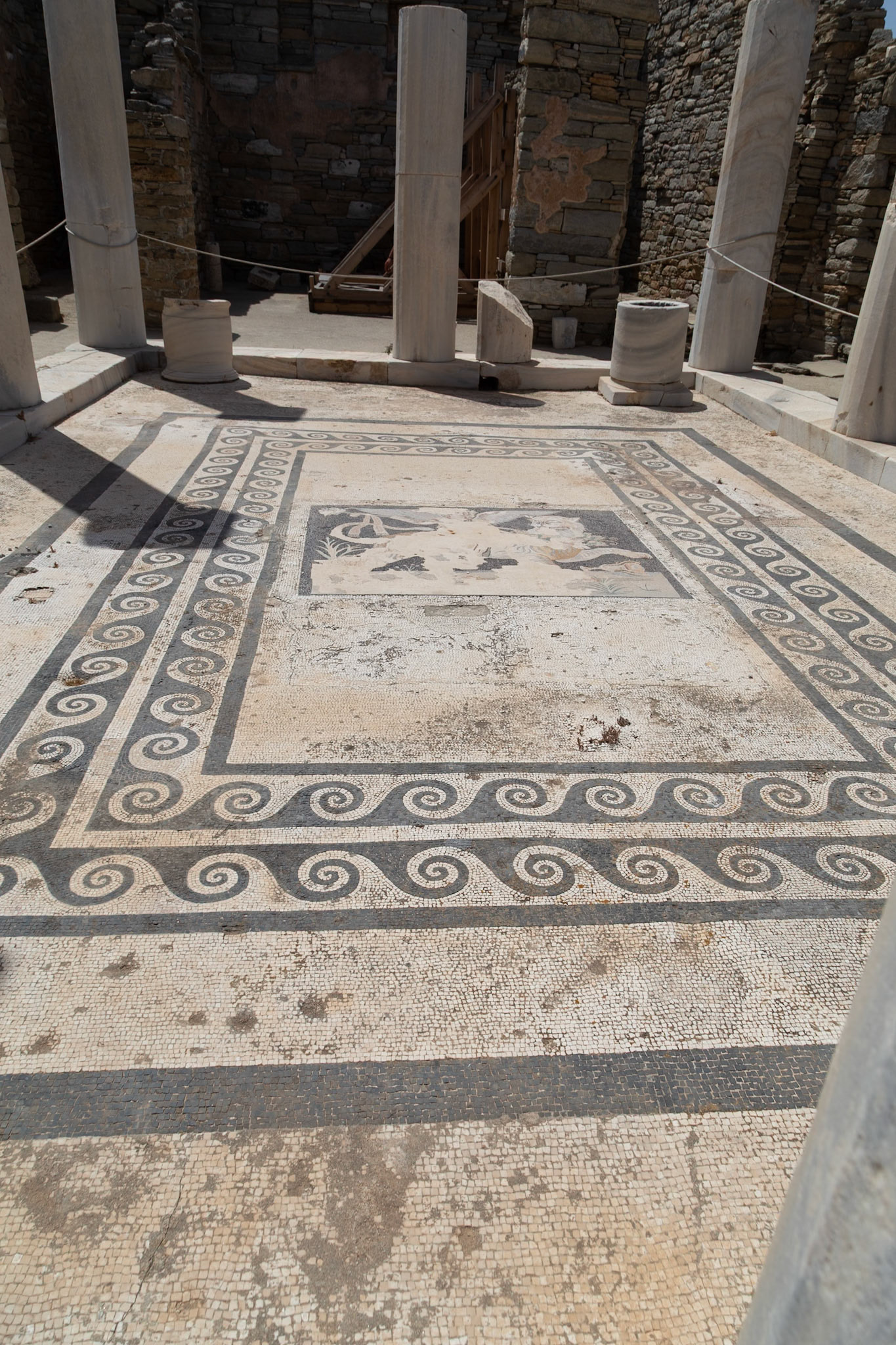 Delos, Greece - May 22nd 2018: An ancient mosaic floor is displayed, showcasing intricate patterns and artistry, preserved as a testament to the island's rich history.