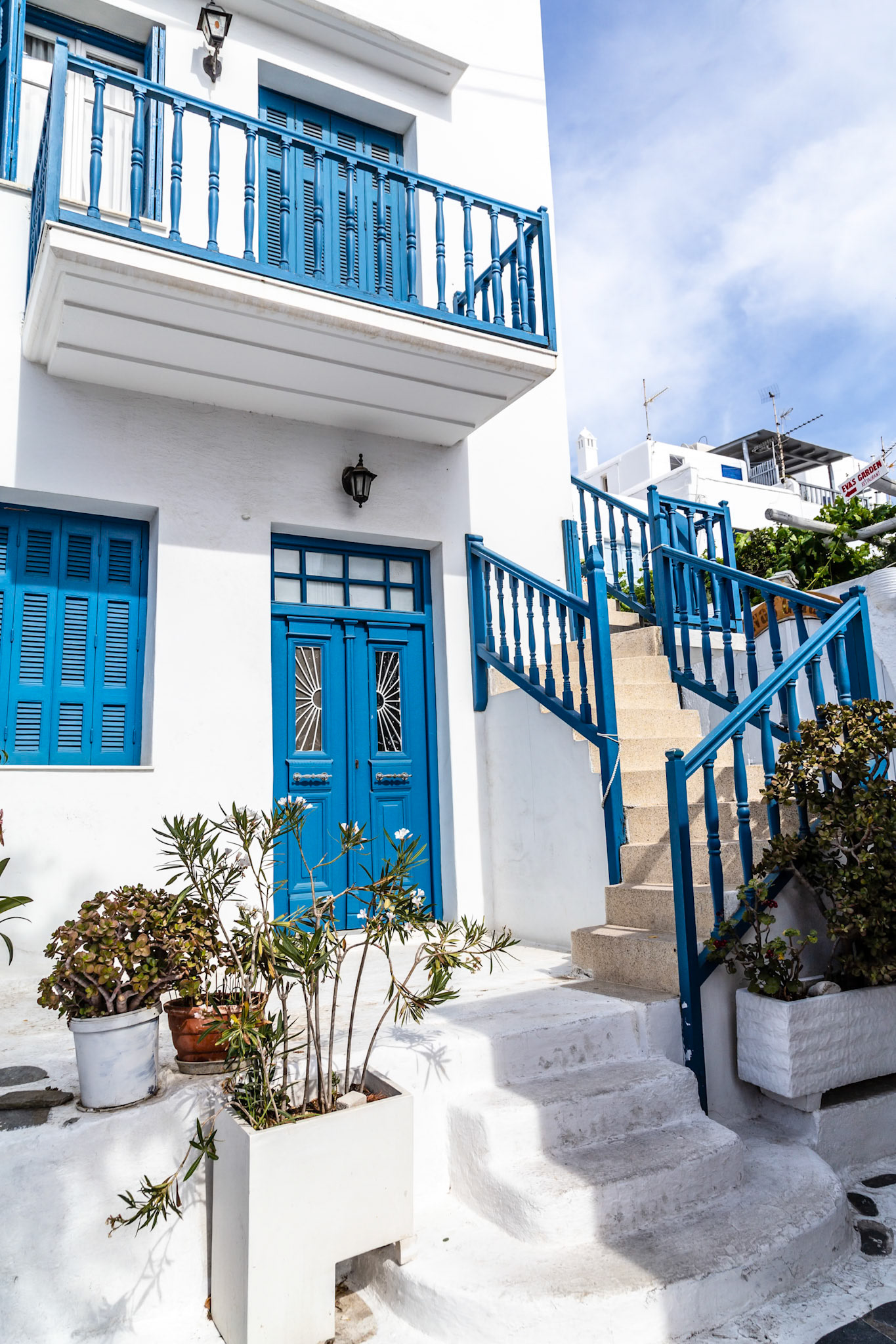 Mykonos, Greece - May 22nd 2018: A traditional white building with blue accents, showcasing the classic Cycladic architecture.