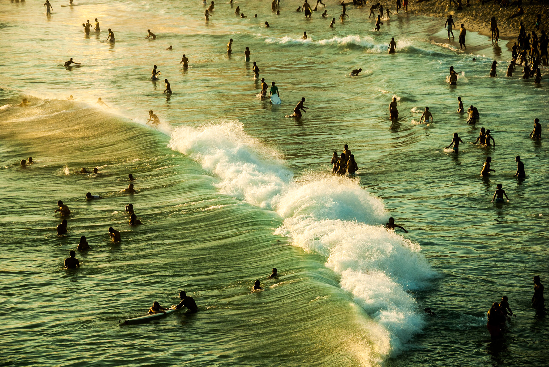 Beachgoers catch the final waves of the day just before sunset off Ipanema Beach, Rio de Janeiro, Sept. 13, 2009. The area is one of the most popular tourist destinations in Brazil and the birthplace of the most popular Brazilian song of the 20th Century, "The Girl from Ipanema."