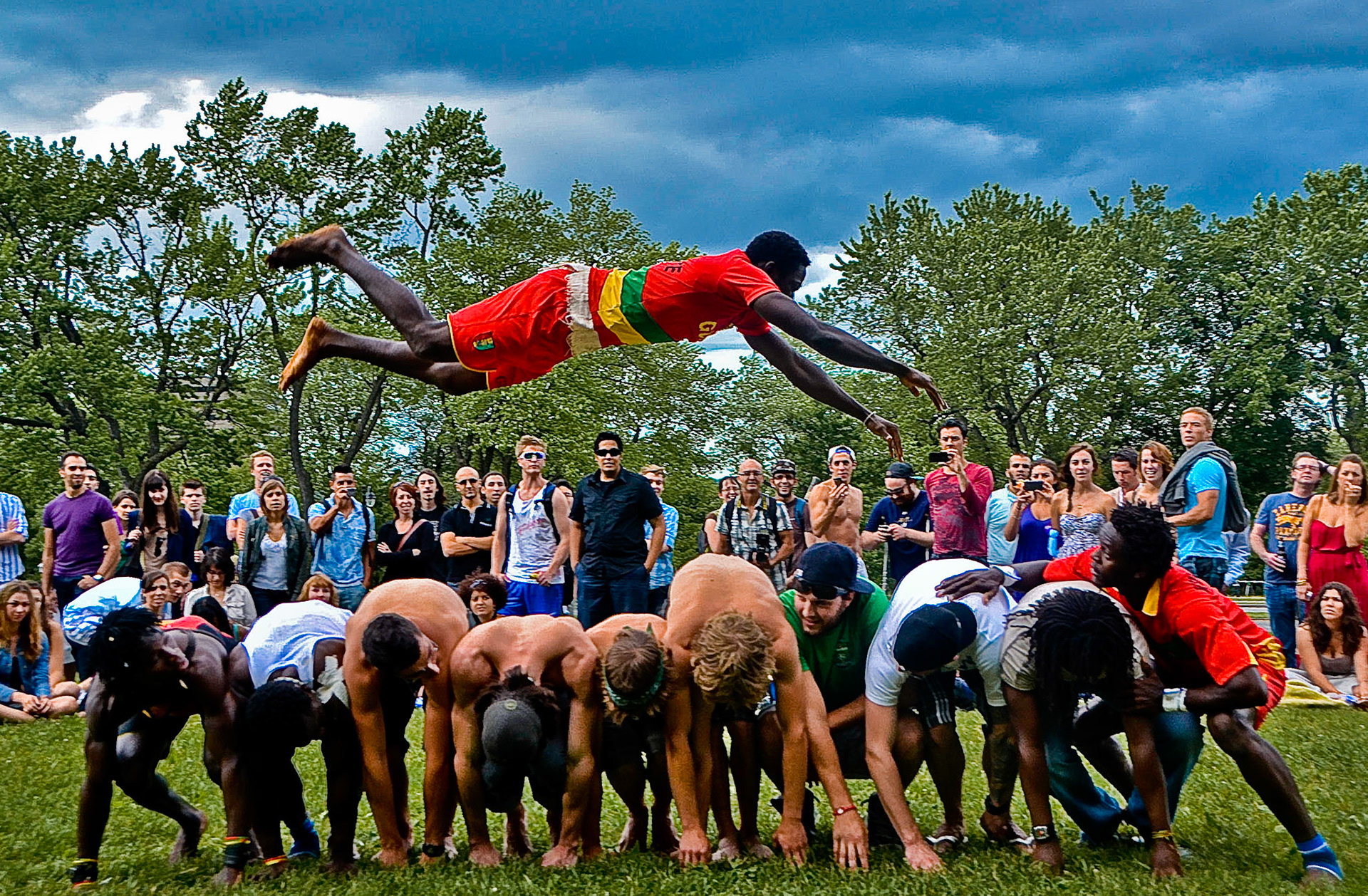A member of Guinean acrobat troupe performs a stunt during a free show for an audience in Parc Mont Royal in Montreal, QCo, June 26, 2011.