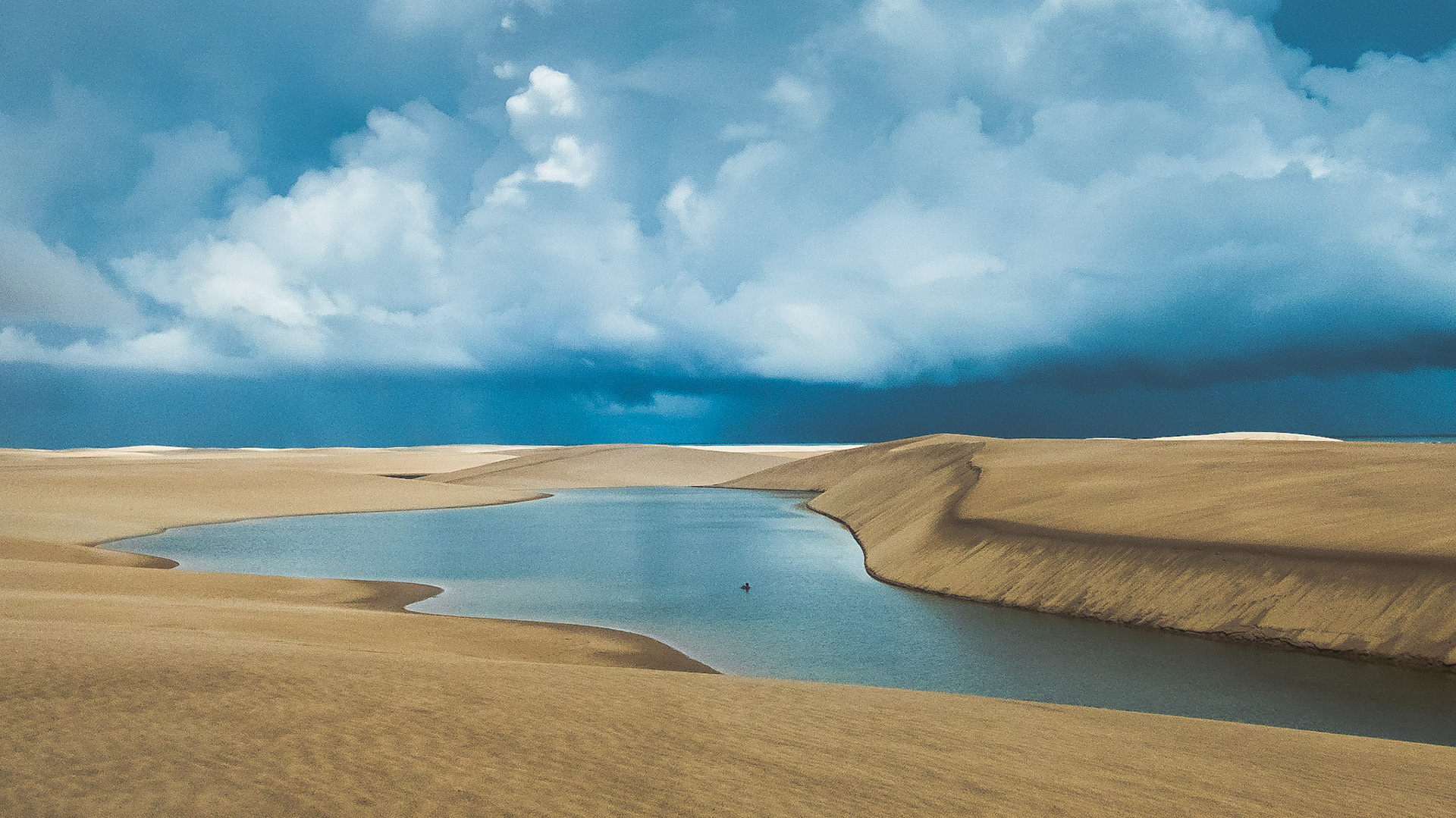 A man stands in the middle of a natural pool in the vast national dune park of Lencois Maranhenses in Northeast Brazil, Feb. 6, 2019. The park, protected in 1981, is home to a range of animal species, has connected lagoons, and though being difficult and costly to reach, is a popular destination for eco toursits.