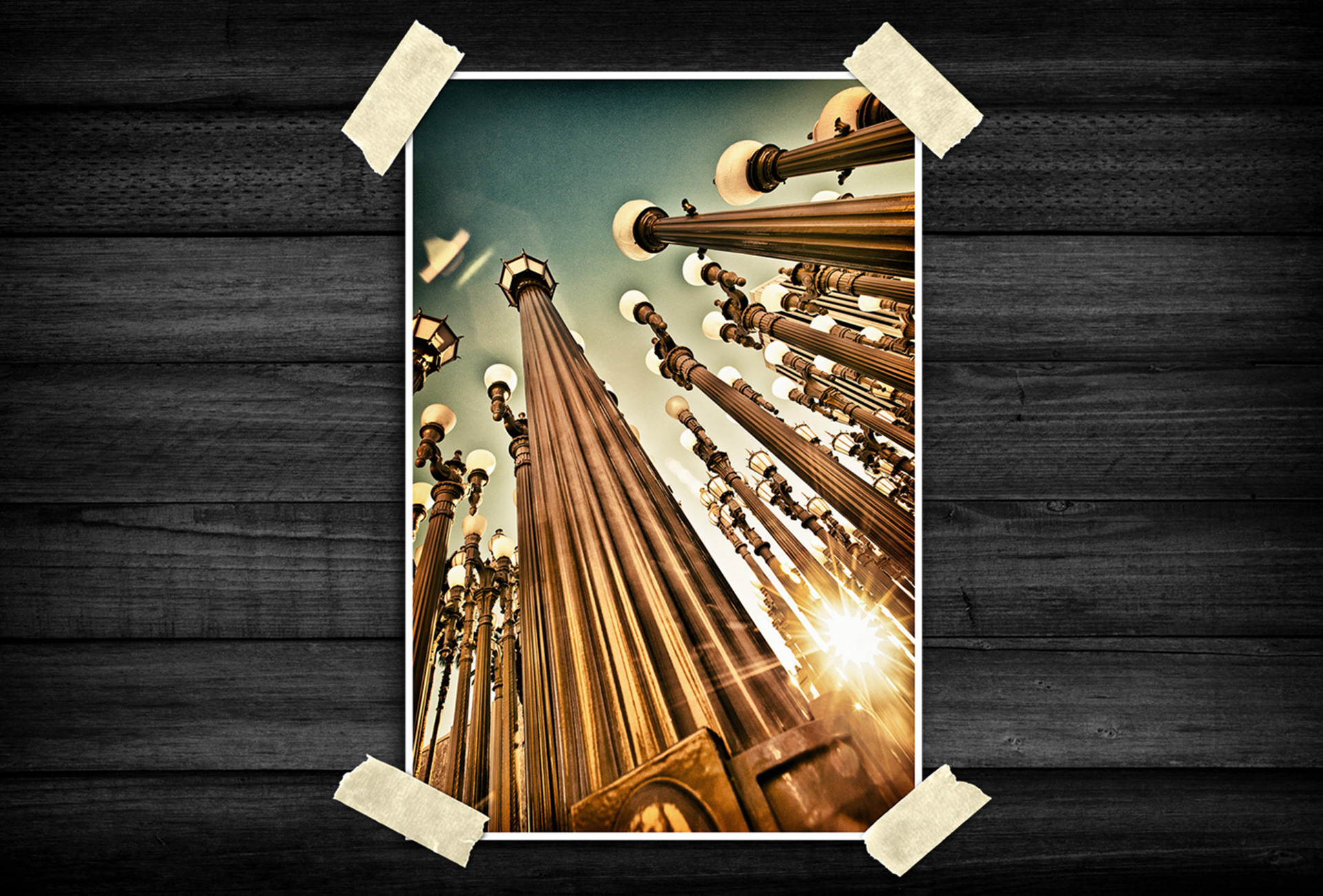 A dynamic upward perspective emphasizes repeating lines and symmetry as vintage-style light structures stretch into the sky. Warm tones and bright sunlight create depth, energy, and a cinematic urban atmosphere.