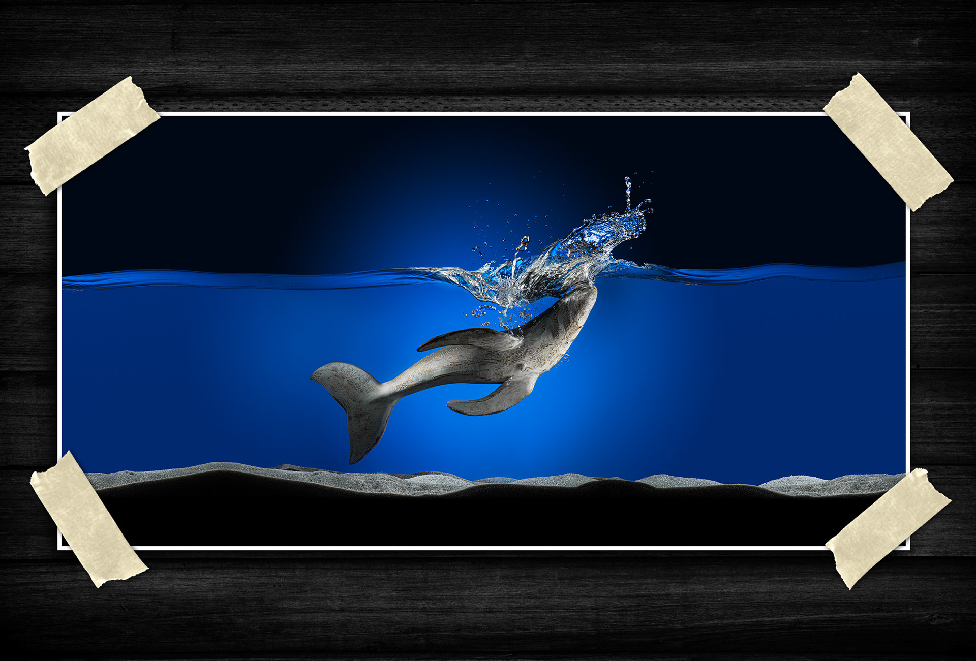An energetic underwater scene where fluid motion and suspended droplets create a sense of speed and impact. Strong blue tones and open space emphasize movement, contrast, and depth.
