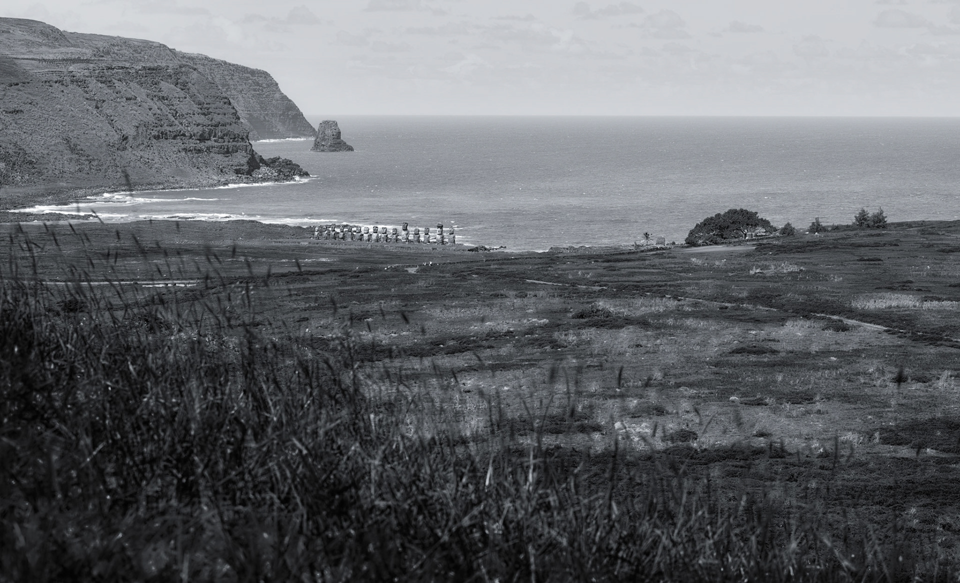 The same Moai in previous photo. This time seen from the quarry on the hilside. These were the most conveniently located Moai relative to the quarry. For scale some small white blips along the road at the T-intersection are folks standing along the stone wall.