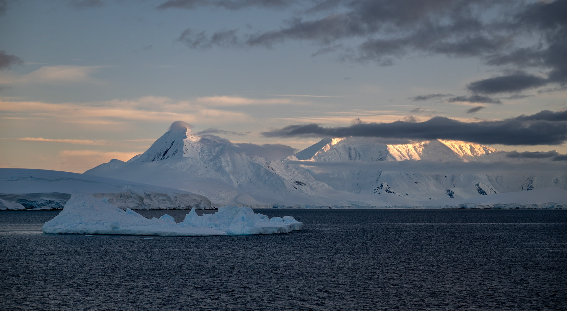 0630 - the sunrise starts to kiss the icey peaks as we approach Lemaire Channel
