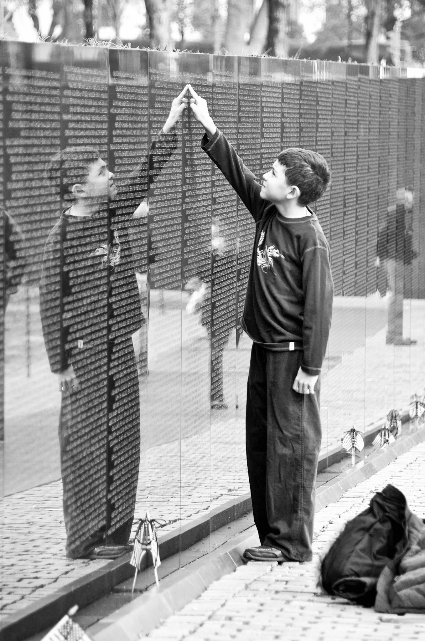 Vietnam War Memorial on a cold December day. Row upon row of names that have a different meaning for this young man.
