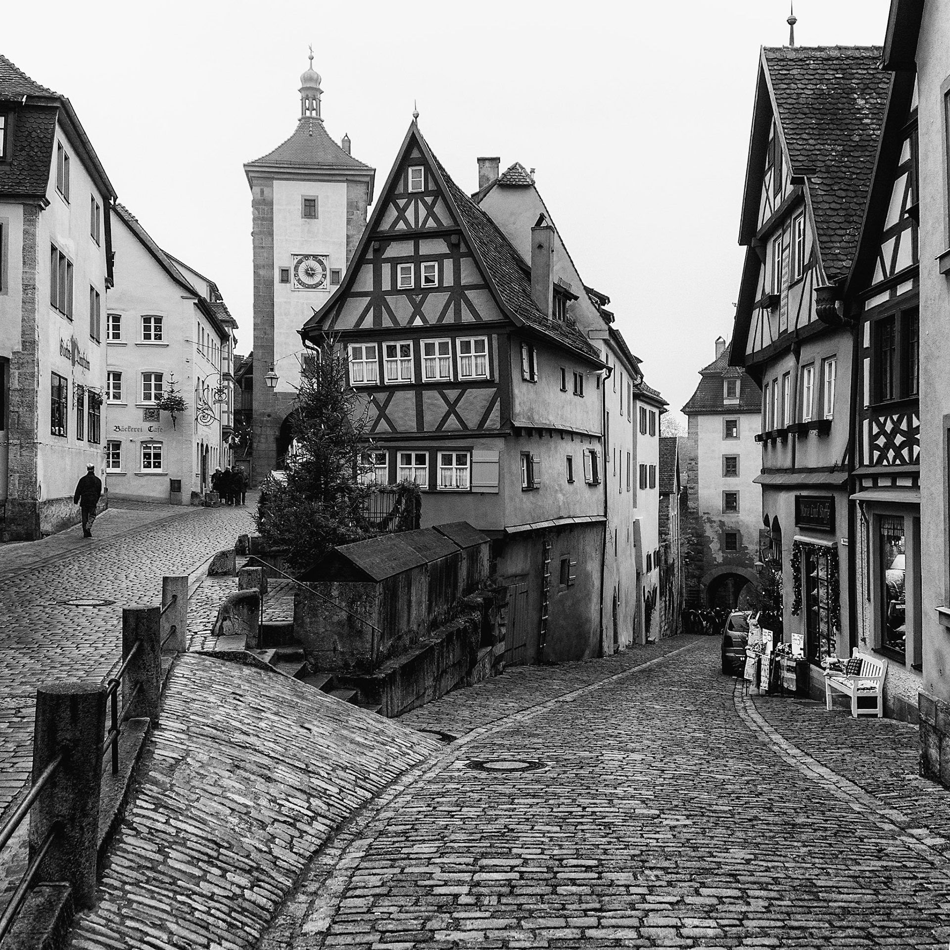 Architecture in the inner wall of the medieval town of Rothenburg, Germany. The itersection of the straight and curved lines of the cobble streets and architecture seemed quaintly out fo place in 2013.