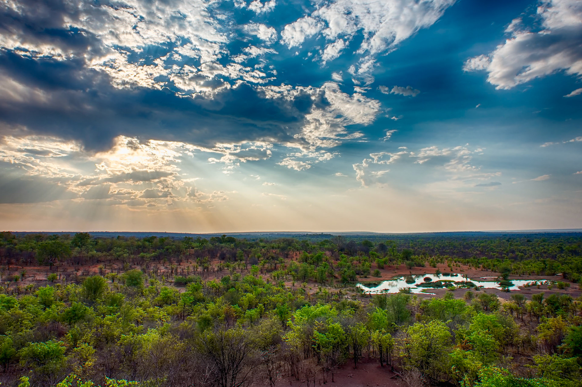The sun getting ready to set at the Victoria Falls Game Lodge watering hole, Zimbabwe
