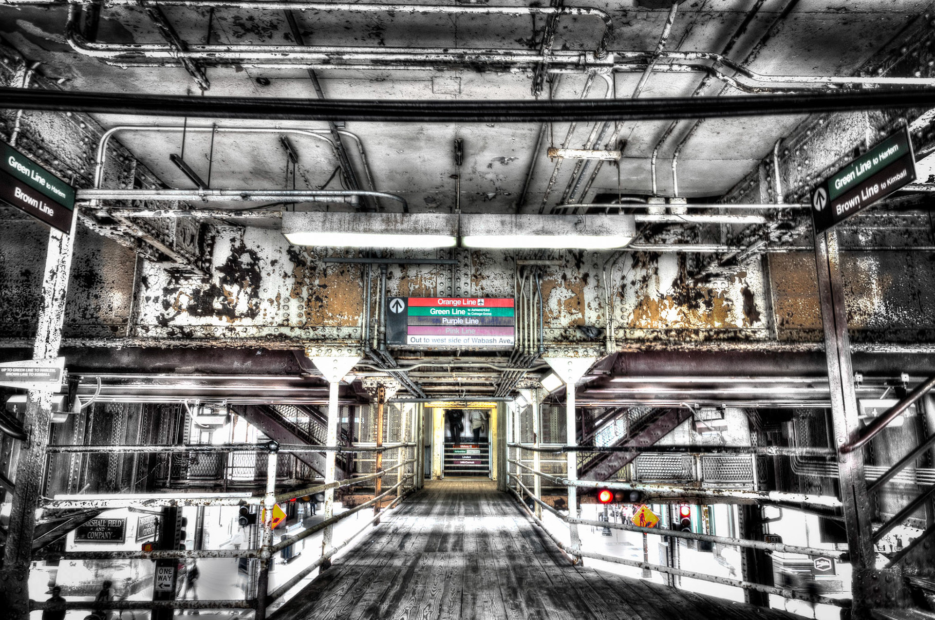 Black and white and abstracted color view of an elevated train station in Chicago.