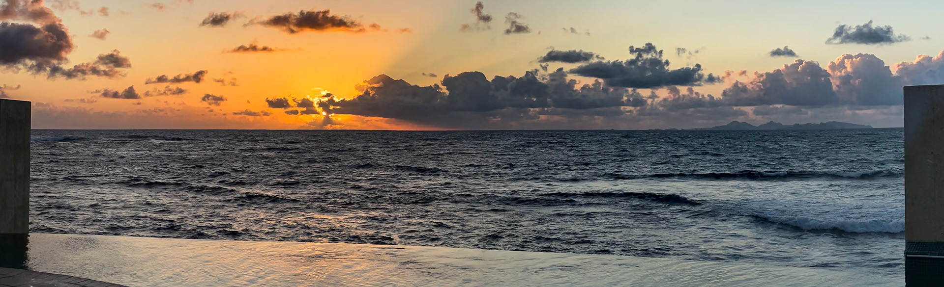 sunrise looking across the infinity edge pool from Oyster Bay Resort