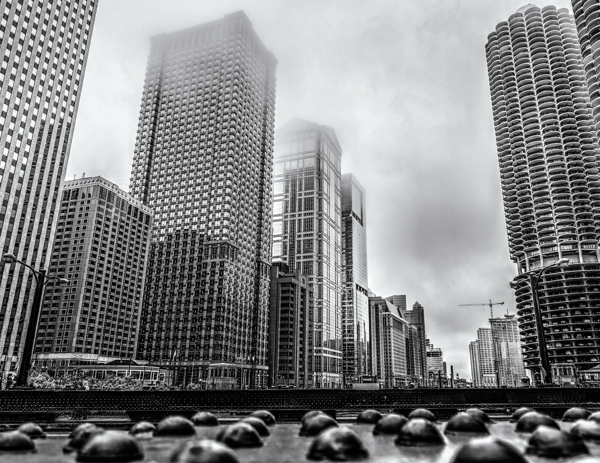 Foggy morning in Chicago as seen from the Columbus Drive Bridge. Look close image right and you'll see several floors of back in parking in the residential buildings. I'm particularly partial to the wonderfully heavy feel of the bridges and rivets which is why I includes those in the foreground.