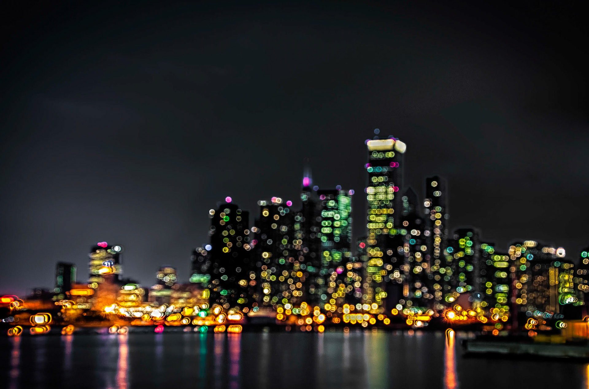 An abstract scene of the Chicago skyline at night as seen from Navy Pier.