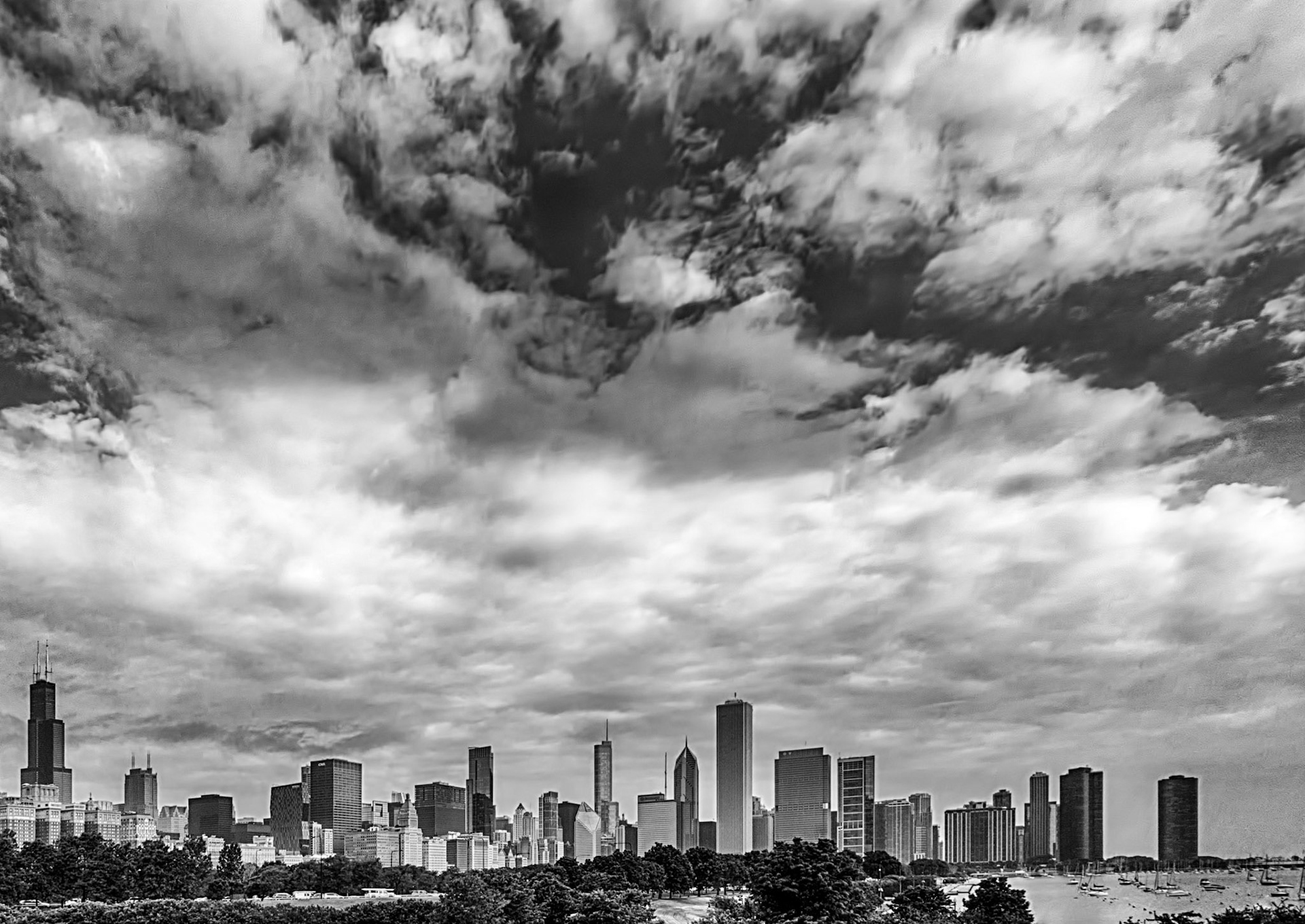 black and white of a big sky over the big chicago skyline as seen from the Field Museum.