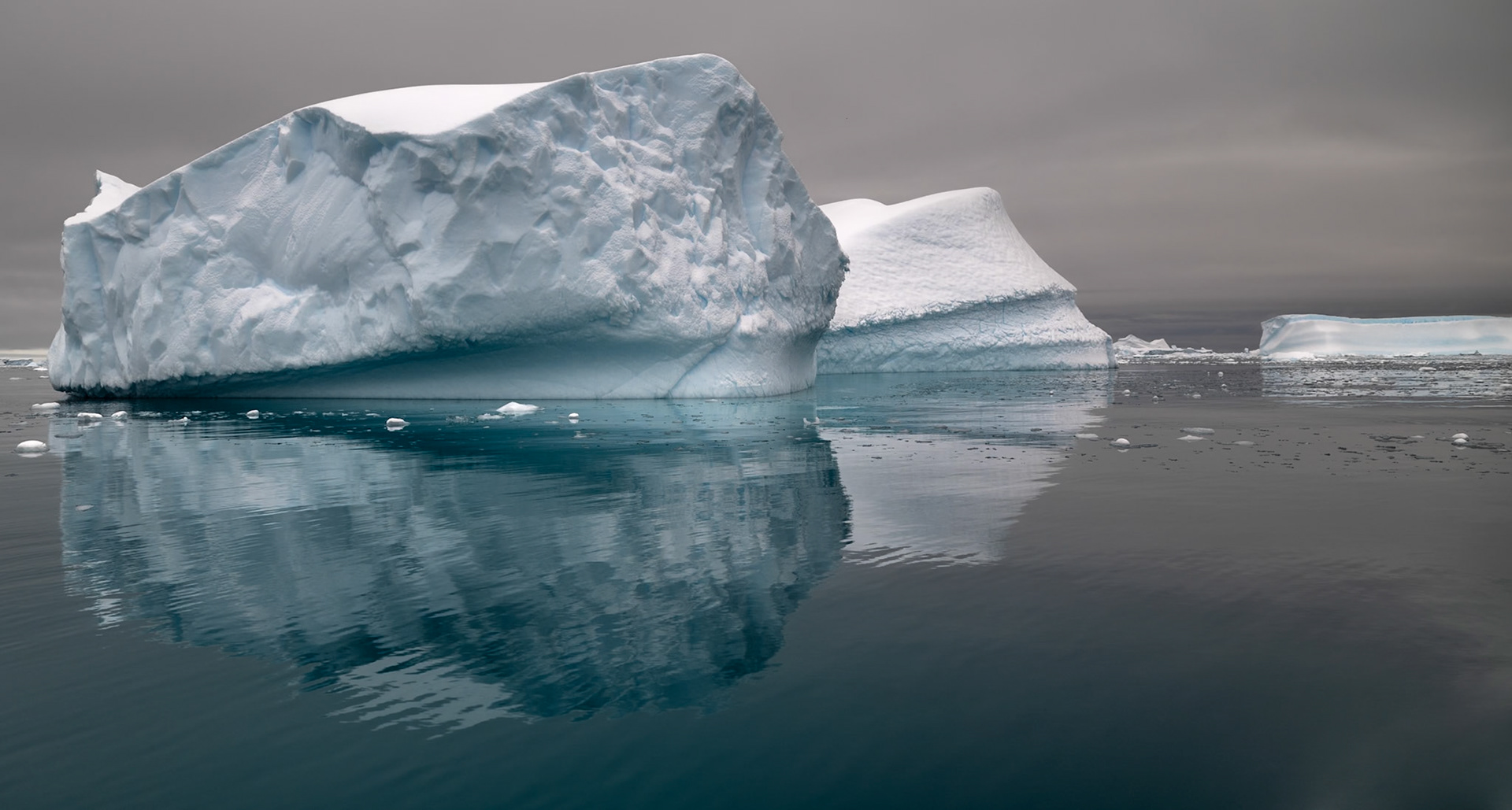 Antartic iceburgs are massive and look even larger reflected in the calm water as we cruise by in our zodiak.