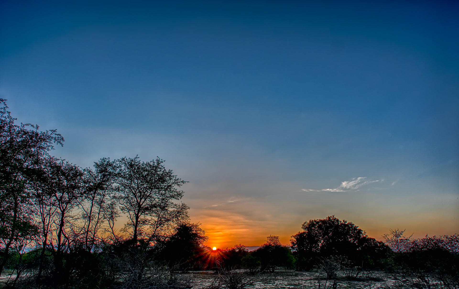 Sun sets as we enjoy sundowner drinks in Thornybush Game Preserve, South Africa. The color of the skies at sunset are always, at the very least, interesting. Sometimes sunsets are also interesting in black and white; checkout this same image processed that way in this gallery.