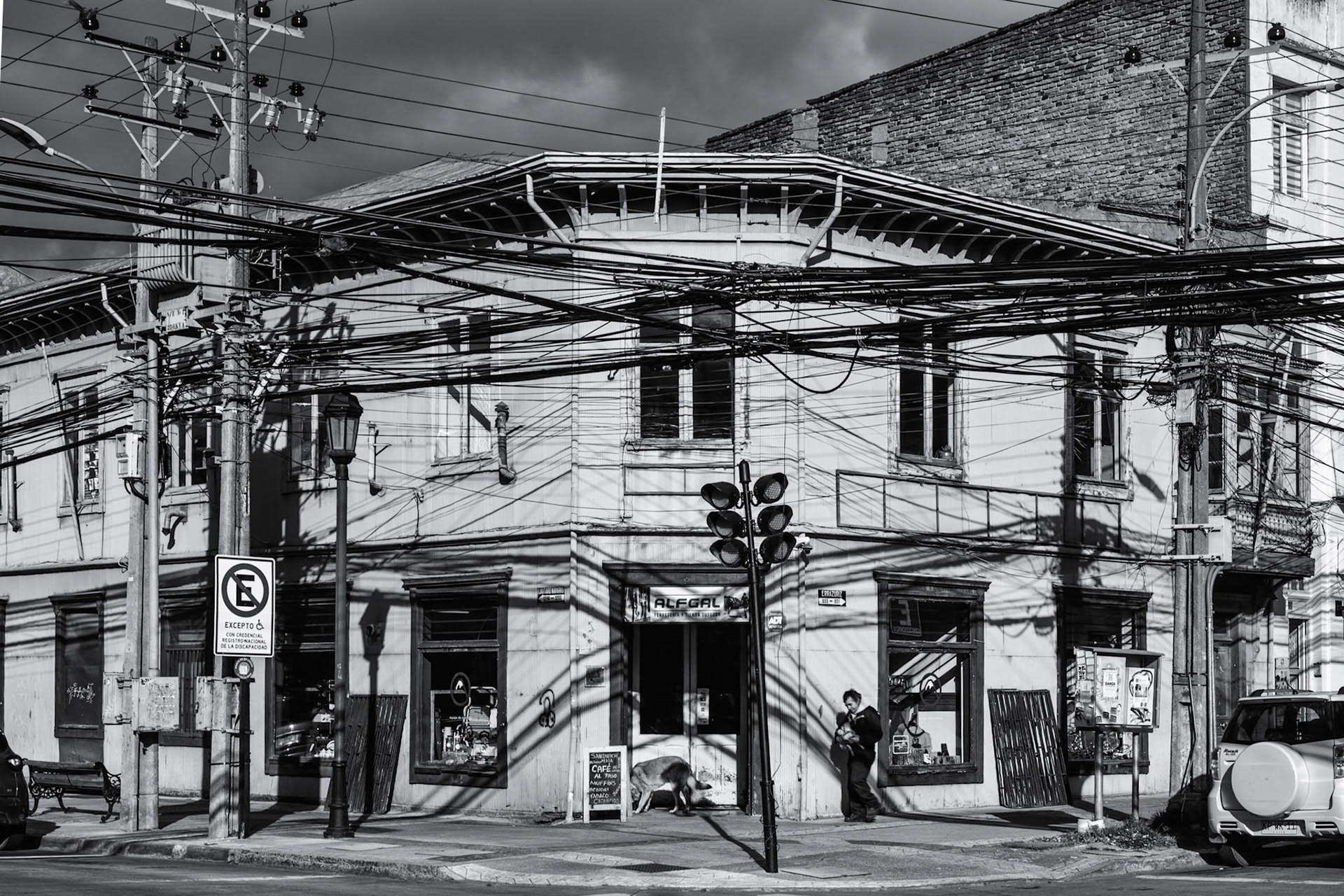 Large delivery vehicles barely clear the abundance of wires (and shadows of wires) in Punta Arenas