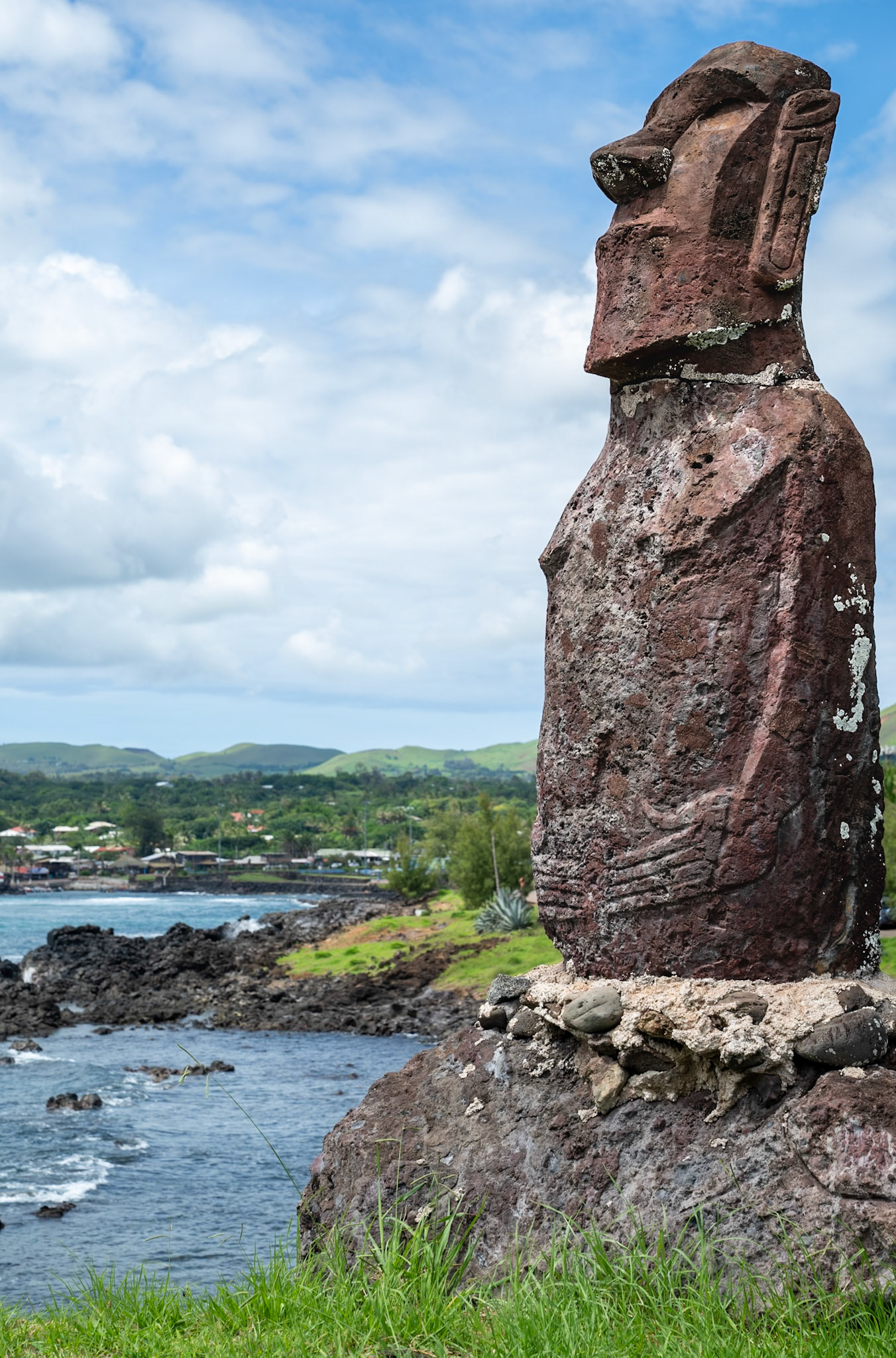A smaller hand carved modern Moai by a local artist. Of note, this modern version is made of red volcanic rock while maintaining the traditional forms and details. Historically the Moai were significantly larger and carved from black volcanic rock from a single location on the island.