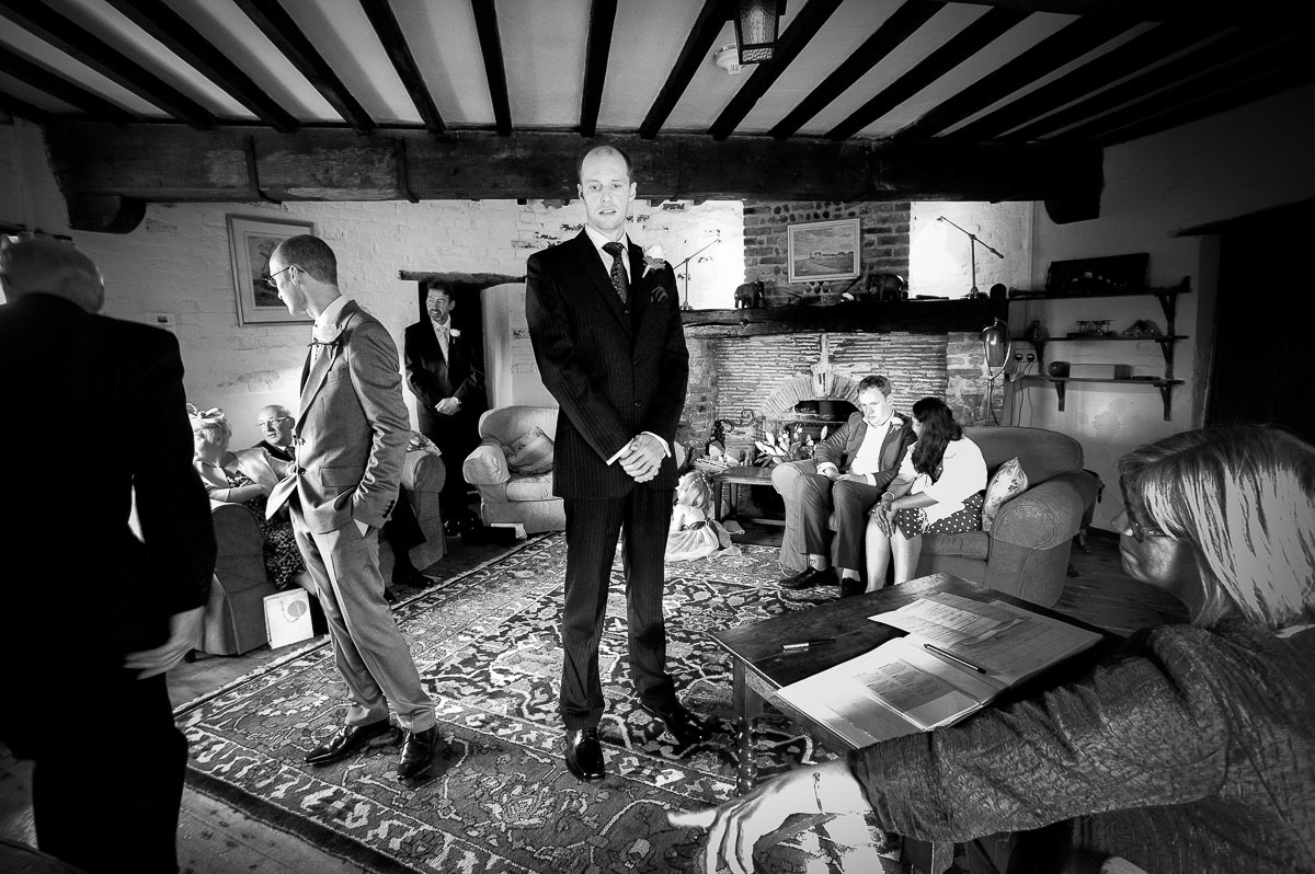 The groom nervously awaiting the bride at a Cley Windmill wedding.
