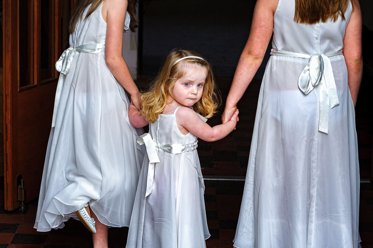 A bridesmaid’s nervous glance back to her mum, the bride, while waiting to walk down the aisle