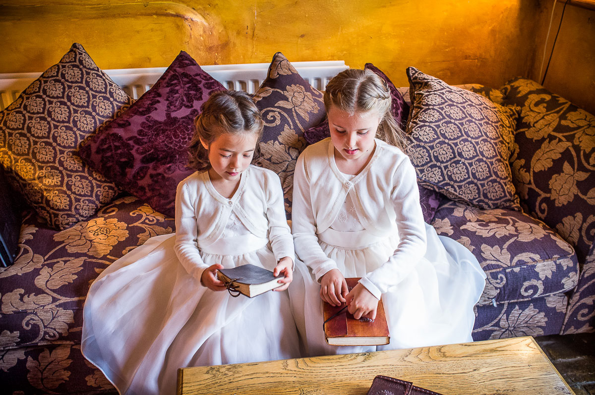 oung bridesmaids waiting while bride gets ready at a Suffolk wedding.