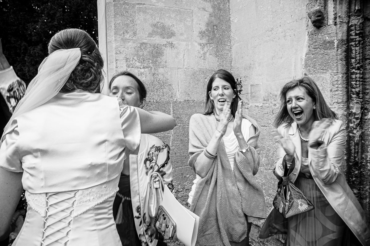 Friends waiting to congratulate the bride at a Cambridge wedding.