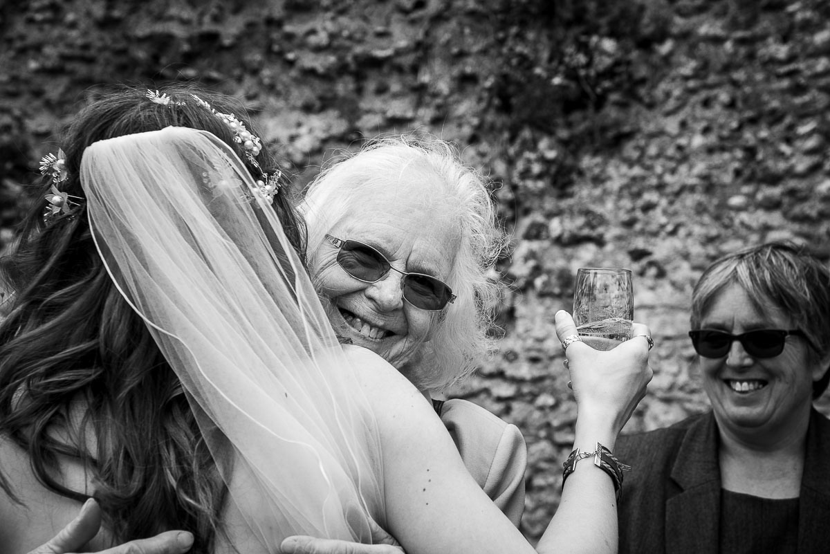 Bride being congratulated by her grandmother at a Suffolk wedding