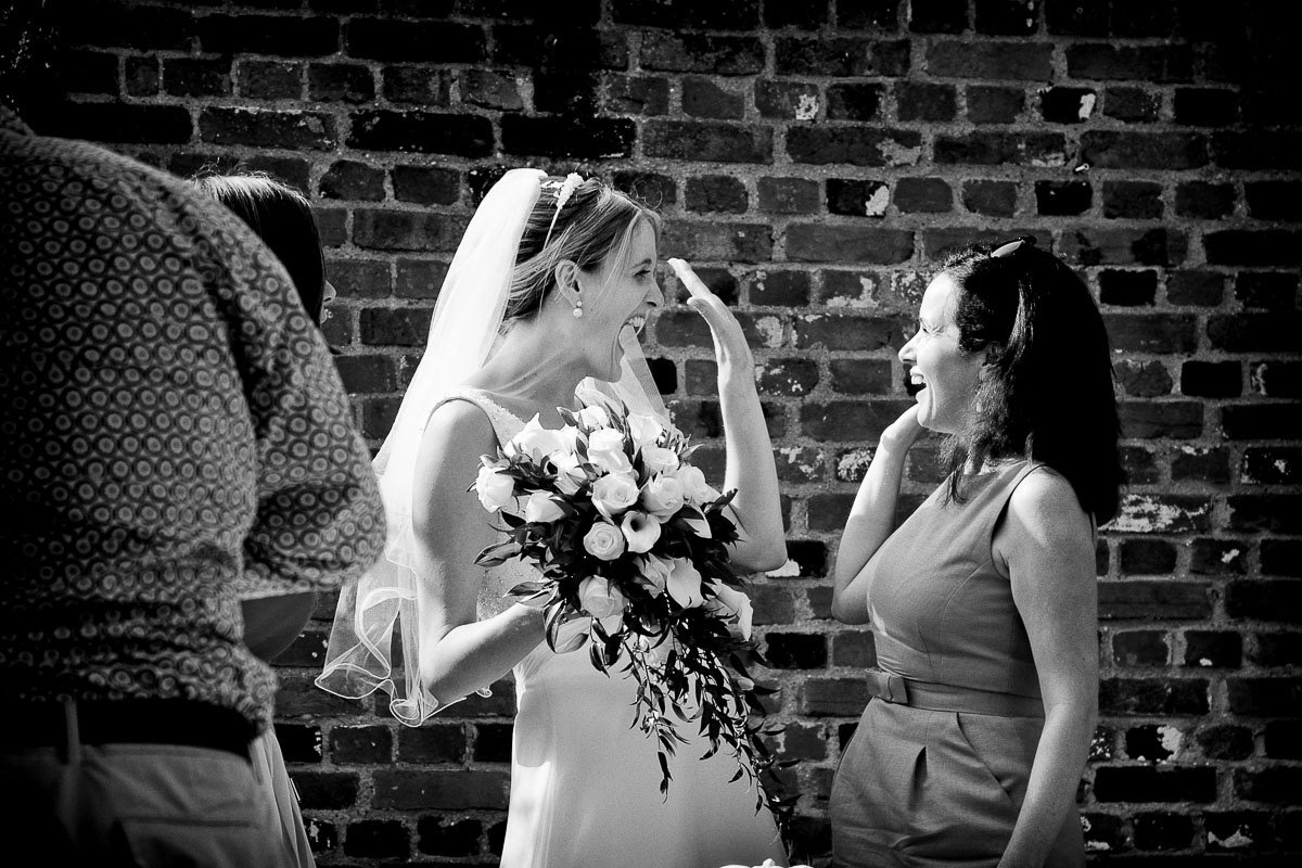 The bride and her friend celebrate at a Suffolk wedding