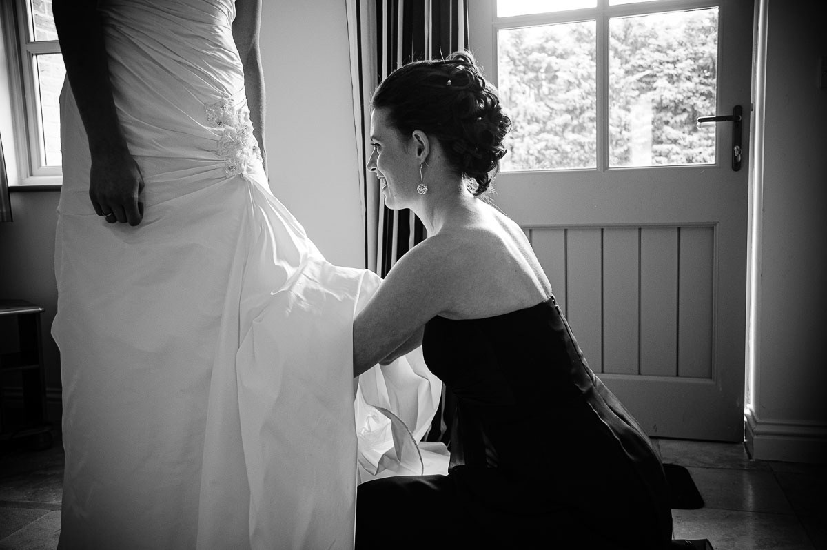 “Arranging” the bridal gown during preparations for a Norwich Cathedral wedding