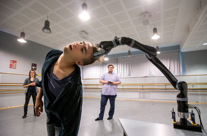 A dance student dancing with a robot arm, Kaleva