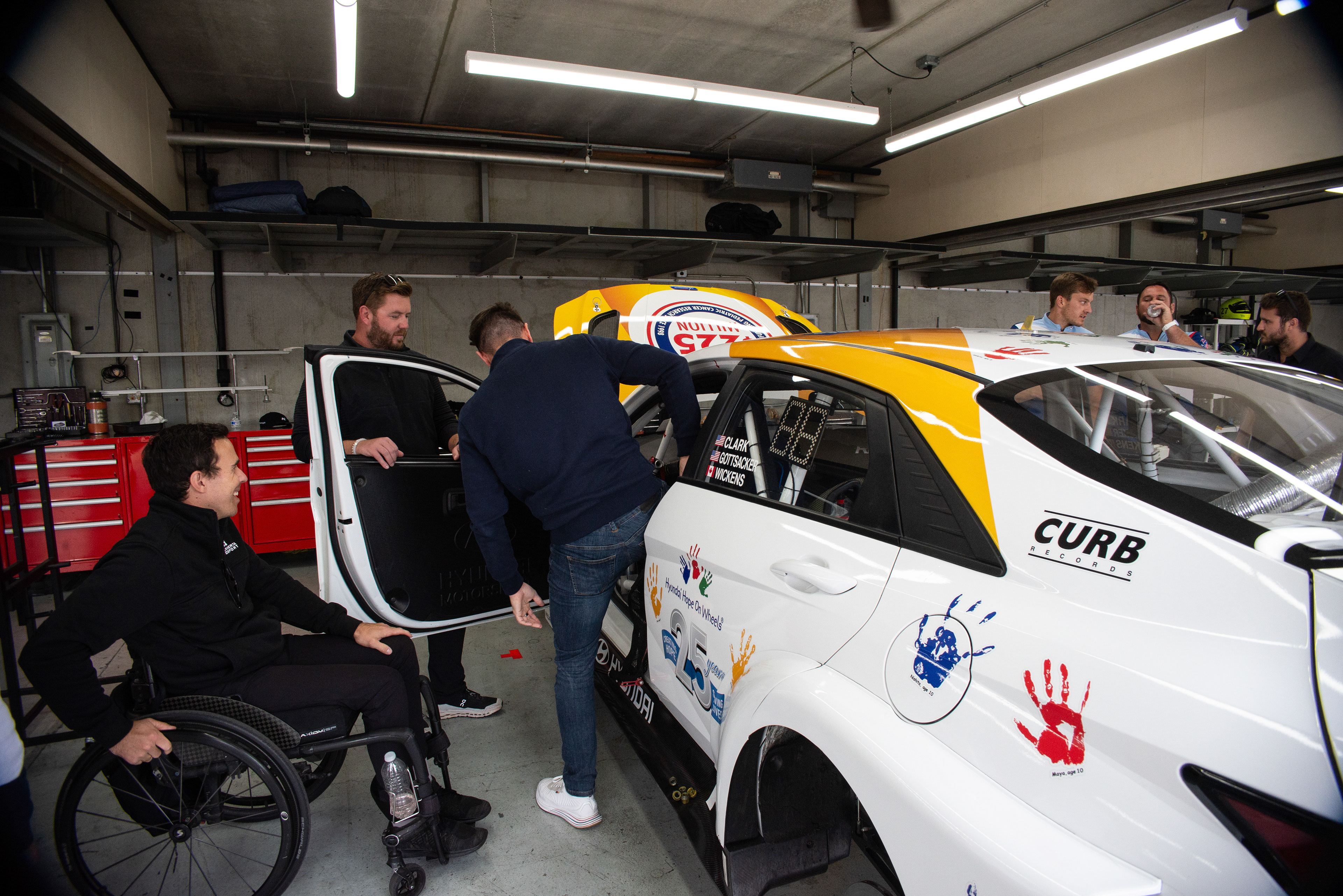 Bryan Herta Motorsports Driver Robert Wickens (seated) shows his hand controls for driving the number 33 Hyundai.