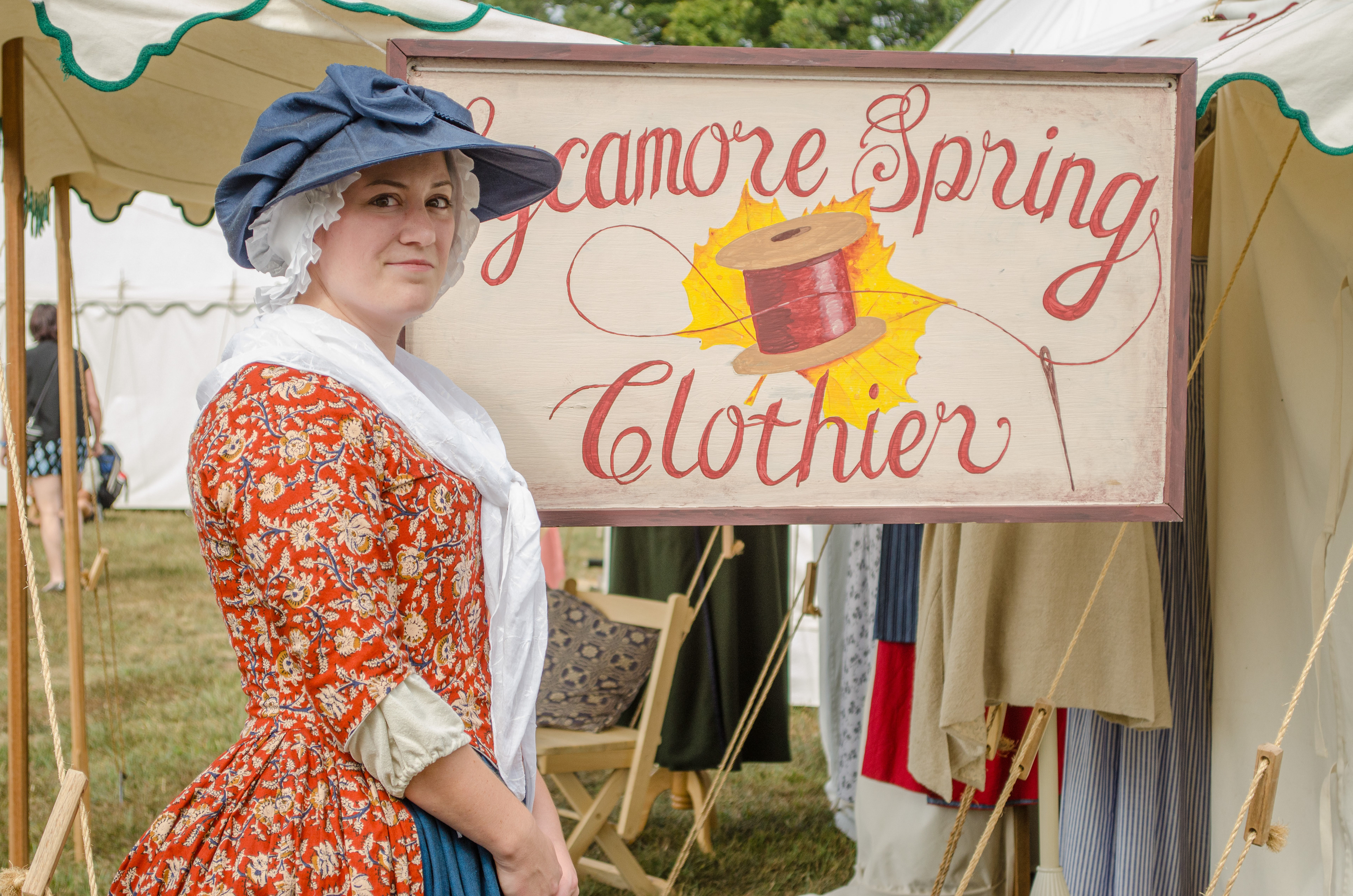 Mallory Christine of Sycamore Spring Clothiers pauses next to her hand painted sign during the Colonial  Market & Fair at George Washingtons Mount Vernon.