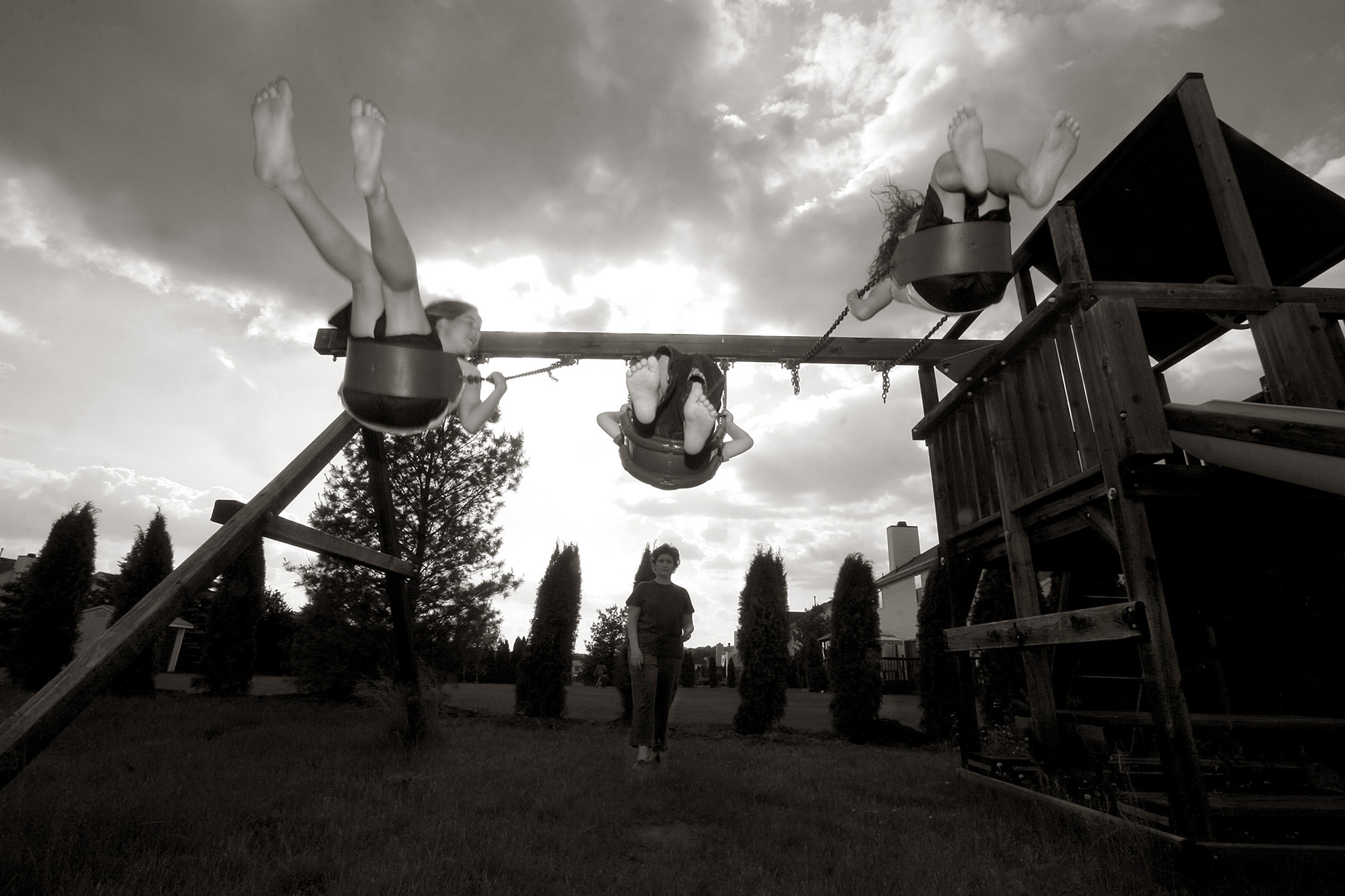 Eric swinging with his sister and friend.