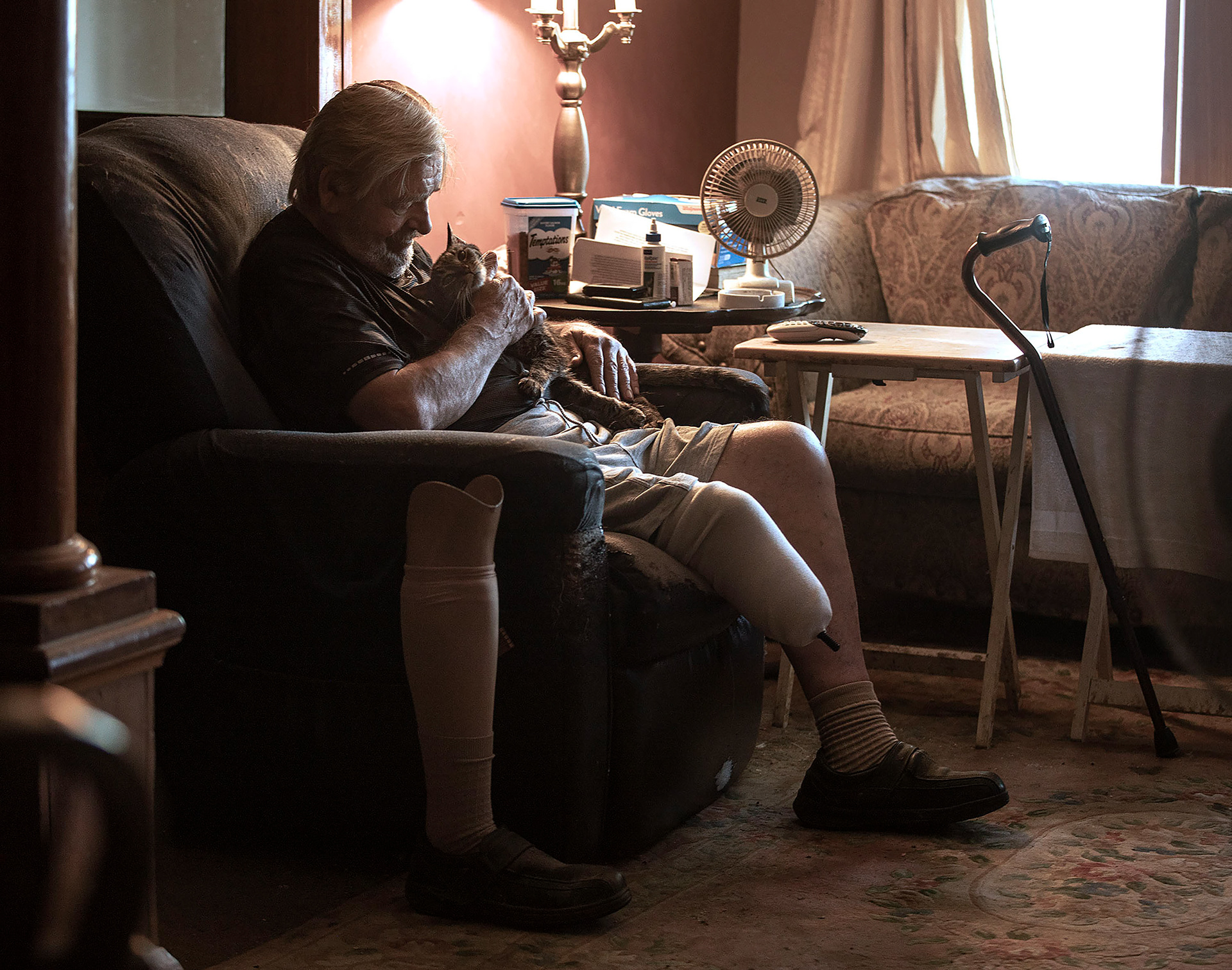 Ken Johnson with his senior cat, Tully, in Easton on Thursday June 30, 2022. Johnson adopted Tully from the FURR program which matches seniors with senior cats to adopt. 