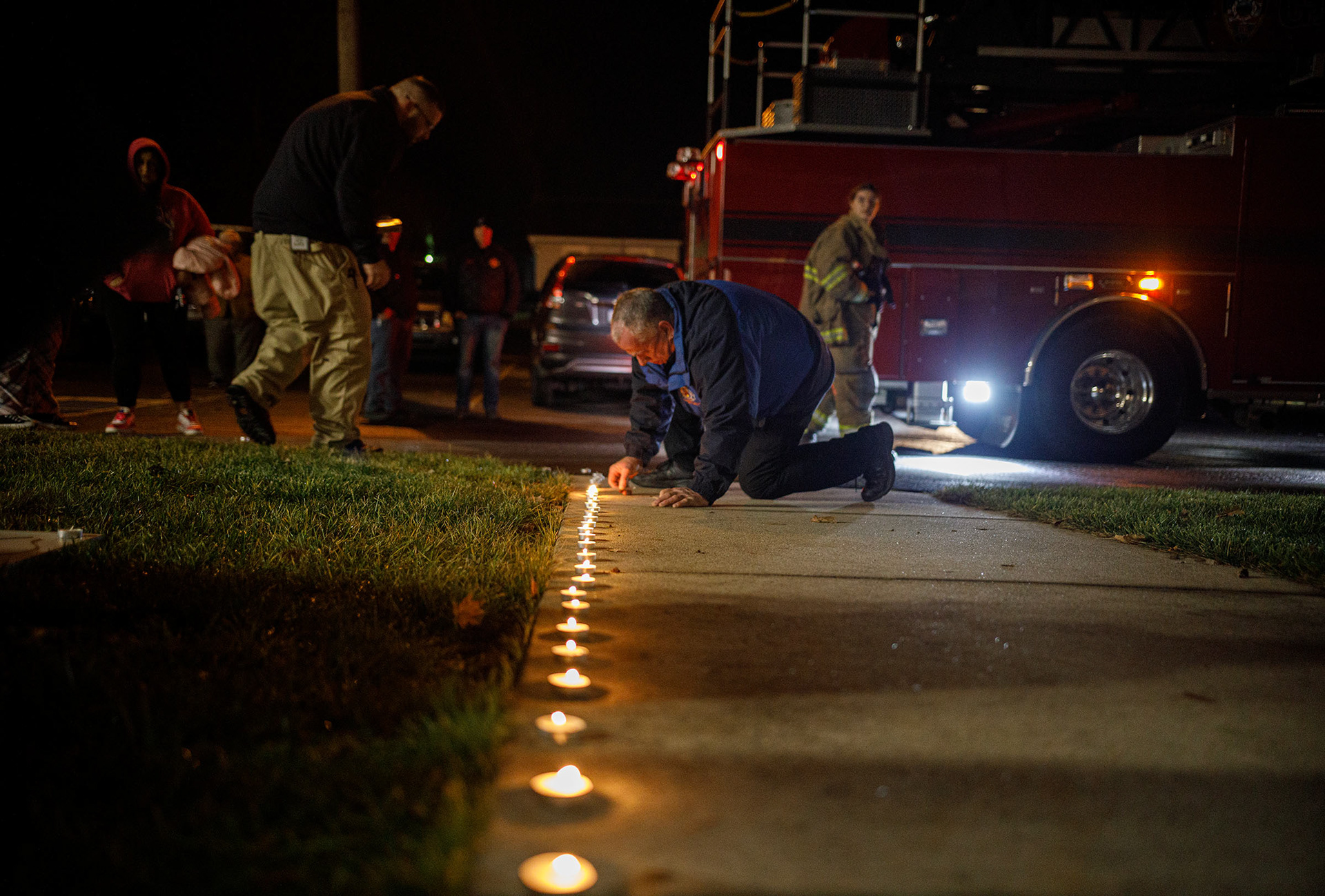 One year later, Sid Madtes, New Tripoli Fire Police Lt., lights candles during a candlelight vigil held Thursday, Dec. 7, 2023, for fallen firefighters Zachary Paris and Marvin Gruber outside New Tripoli Fire Station Thursday, Dec. 7, 2023, in Lynn Township.  Paris and Gruber died in the line of duty while fighting a house fire Dec. 7, 2022, in West Penn Township, Schuylkill County. (Jane Therese/Special to The Morning Call)