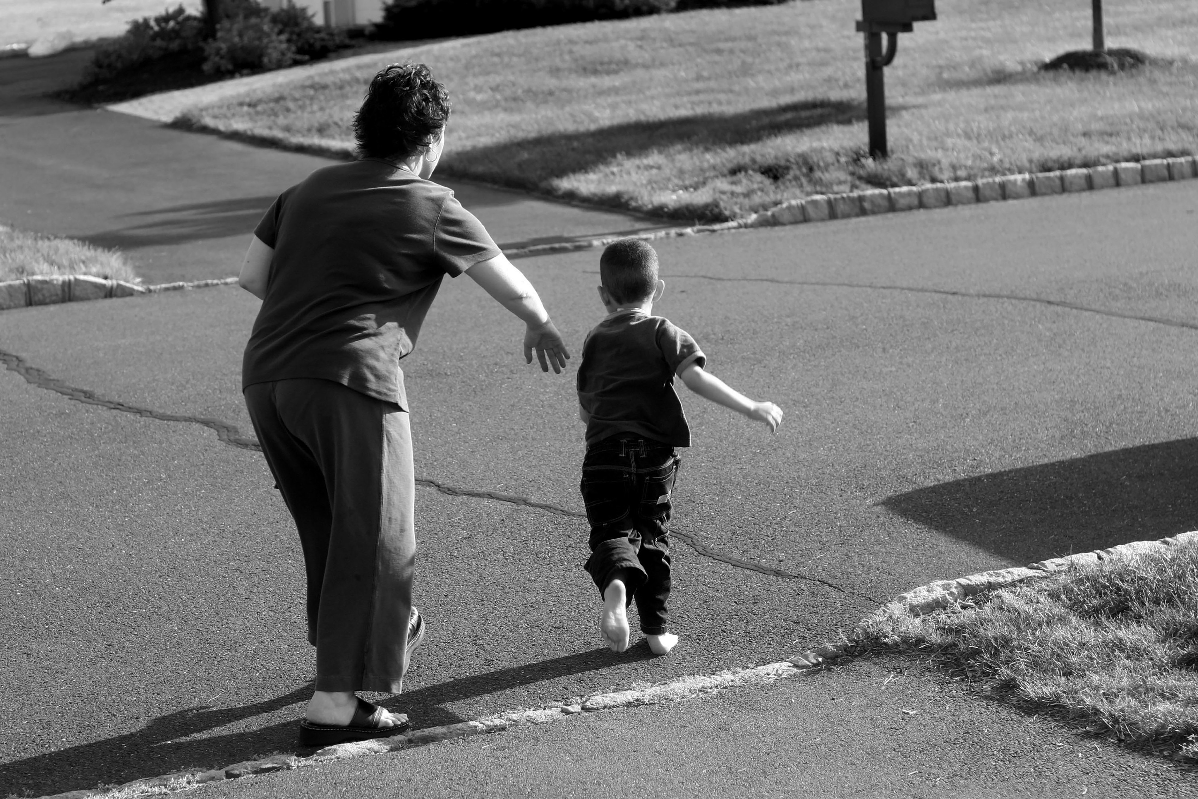 Nancy preventing Eric from running in the street.