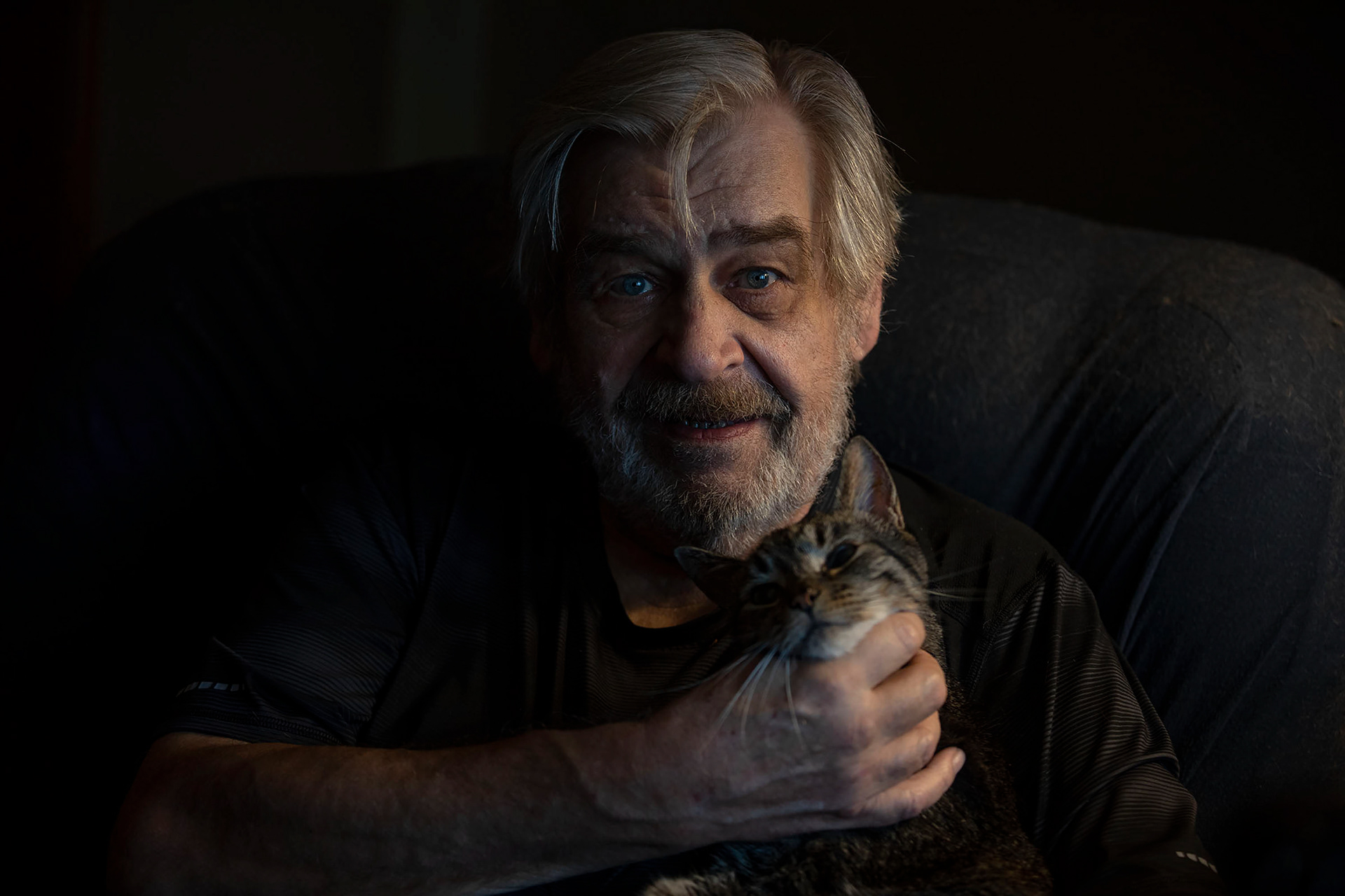 Ken Johnson with his senior cat, Tully, in Easton on Thursday June 30, 2022. Johnson adopted Tully from the FURR program which matches seniors with senior cats to adopt. 