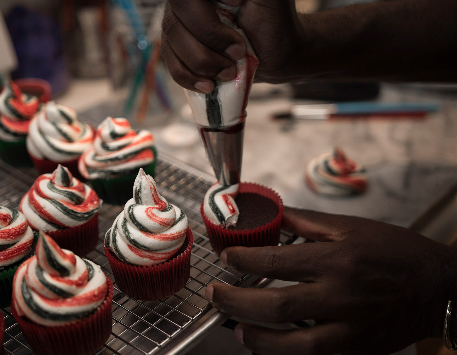 Buki Elegbede of “The Buki Show,” bakes homemade chocolate candy cane swirl cupcakes for the holiday season in Newark. (Jane Therese for Edible New Jersey)