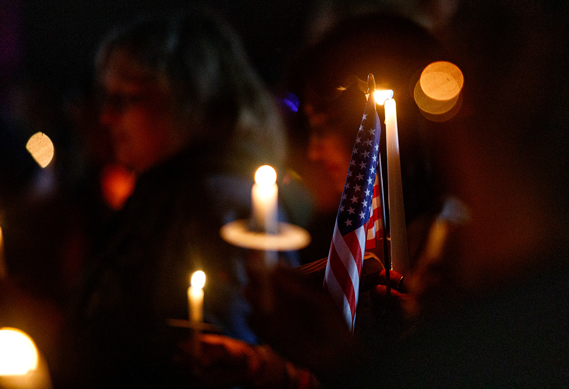 People attend a candelight vigil in memory of slain conservative political activist Charlie Kirk