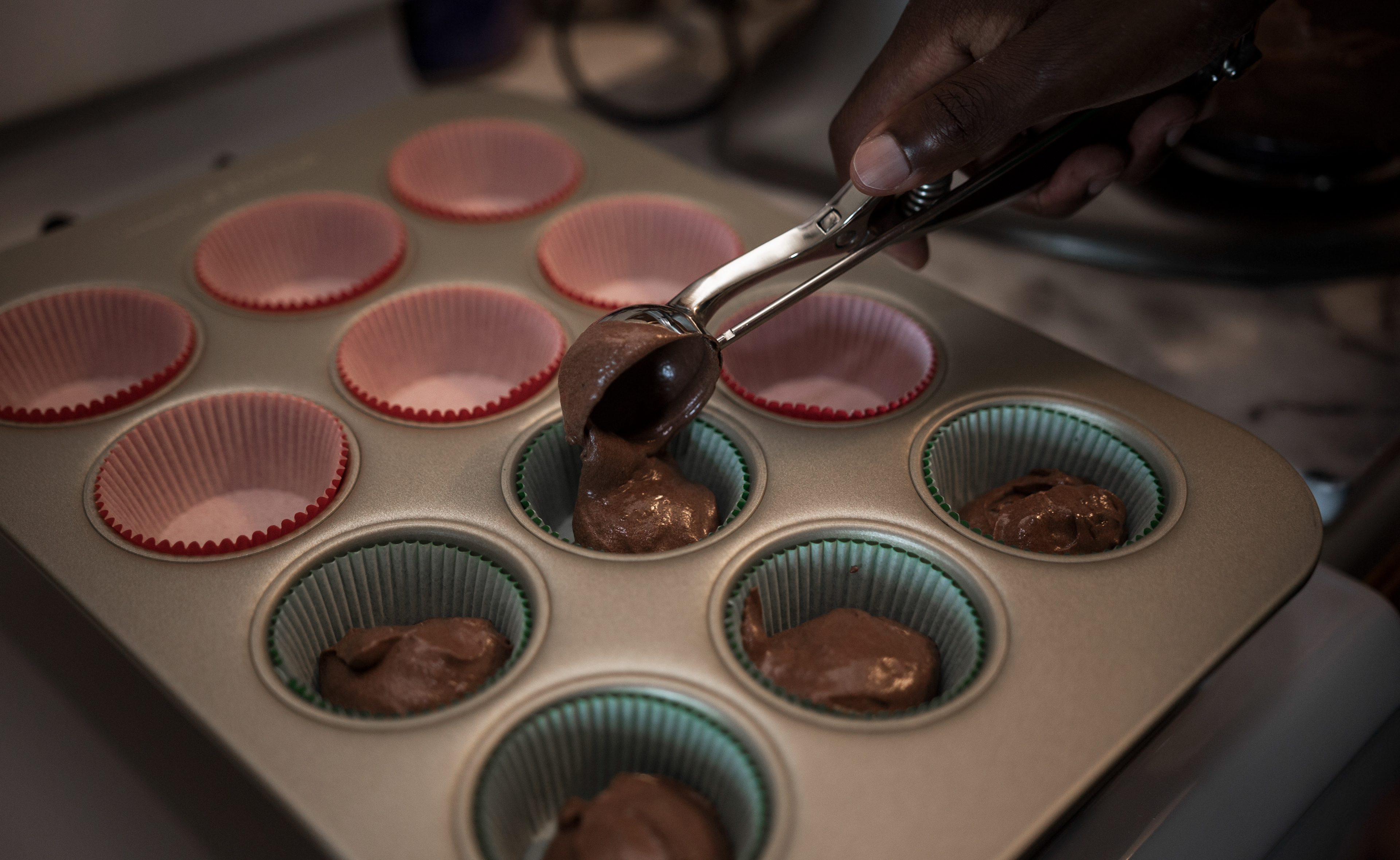 Buki Elegbede of “The Buki Show,” bakes homemade chocolate candy cane swirl cupcakes for the holiday season in Newark. (Jane Therese for Edible New Jersey)