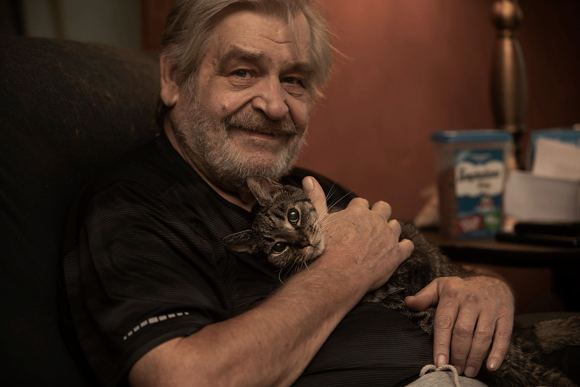 Ken Johnson with his senior cat, Tully, in Easton on Thursday June 30, 2022. Johnson adopted Tully from the FURR program which matches seniors with senior cats to adopt. 