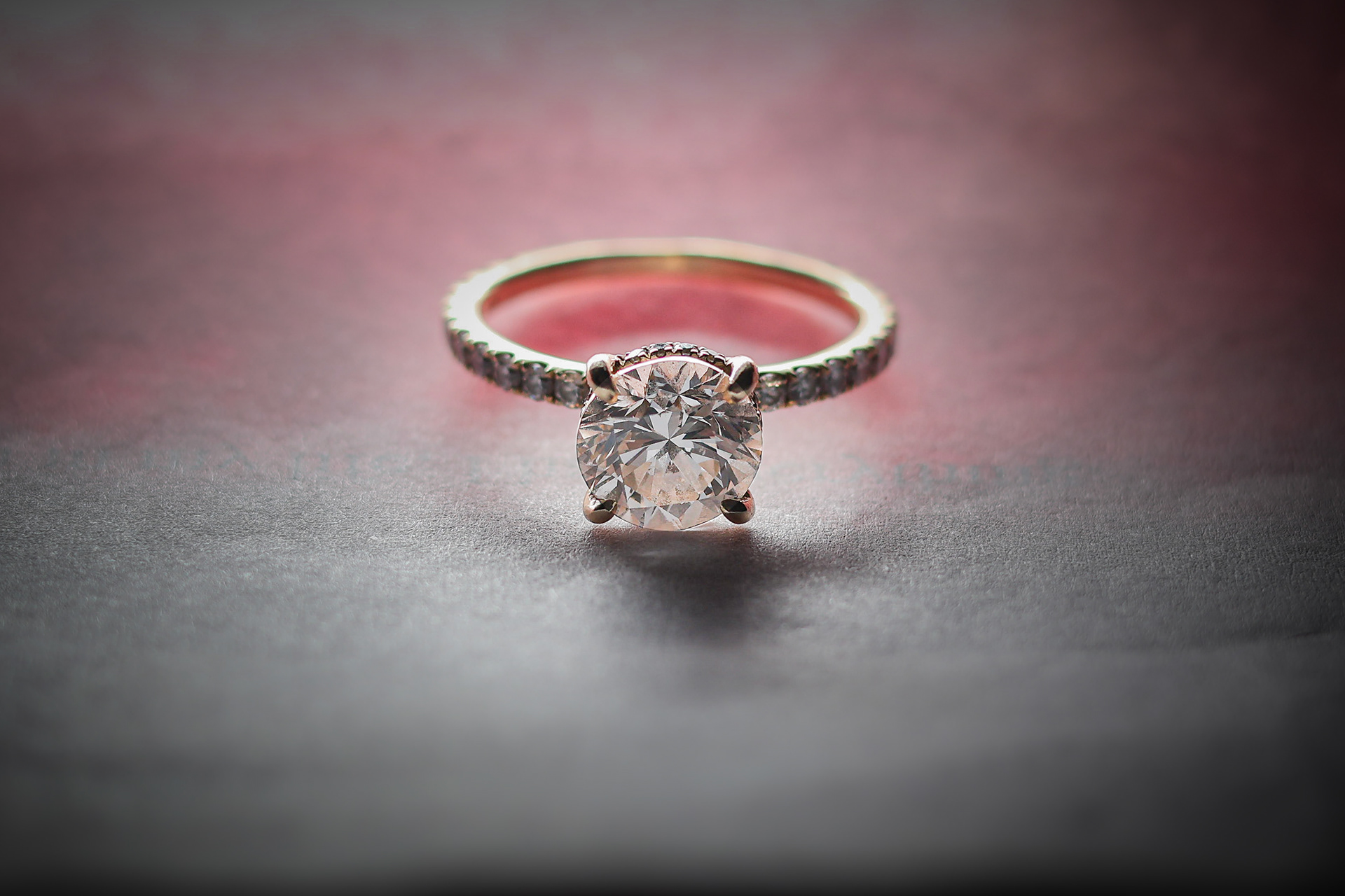 diamond ring sparkling on grey and red background