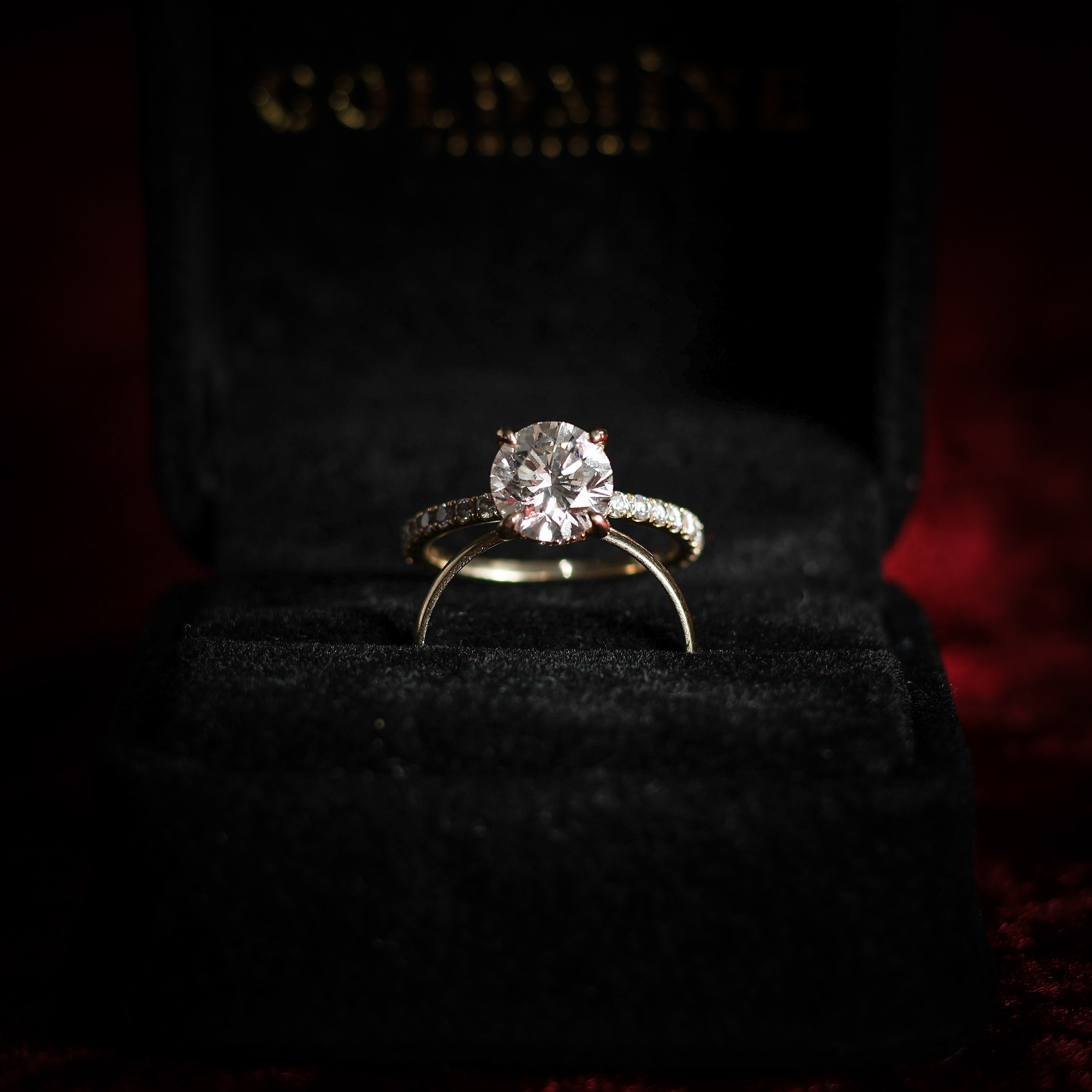 diamond ring in box resting on wedding band