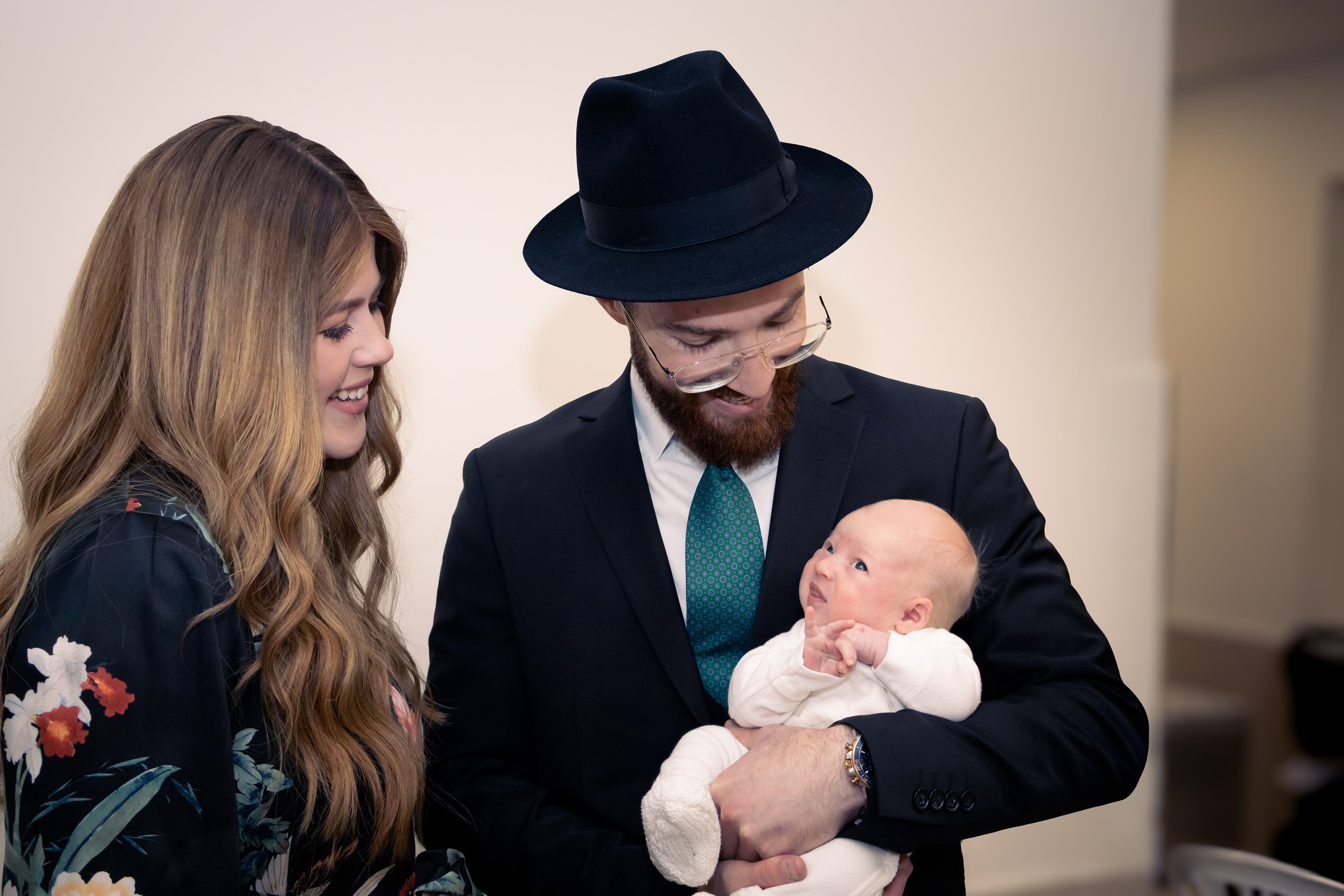 parents smiling down at baby