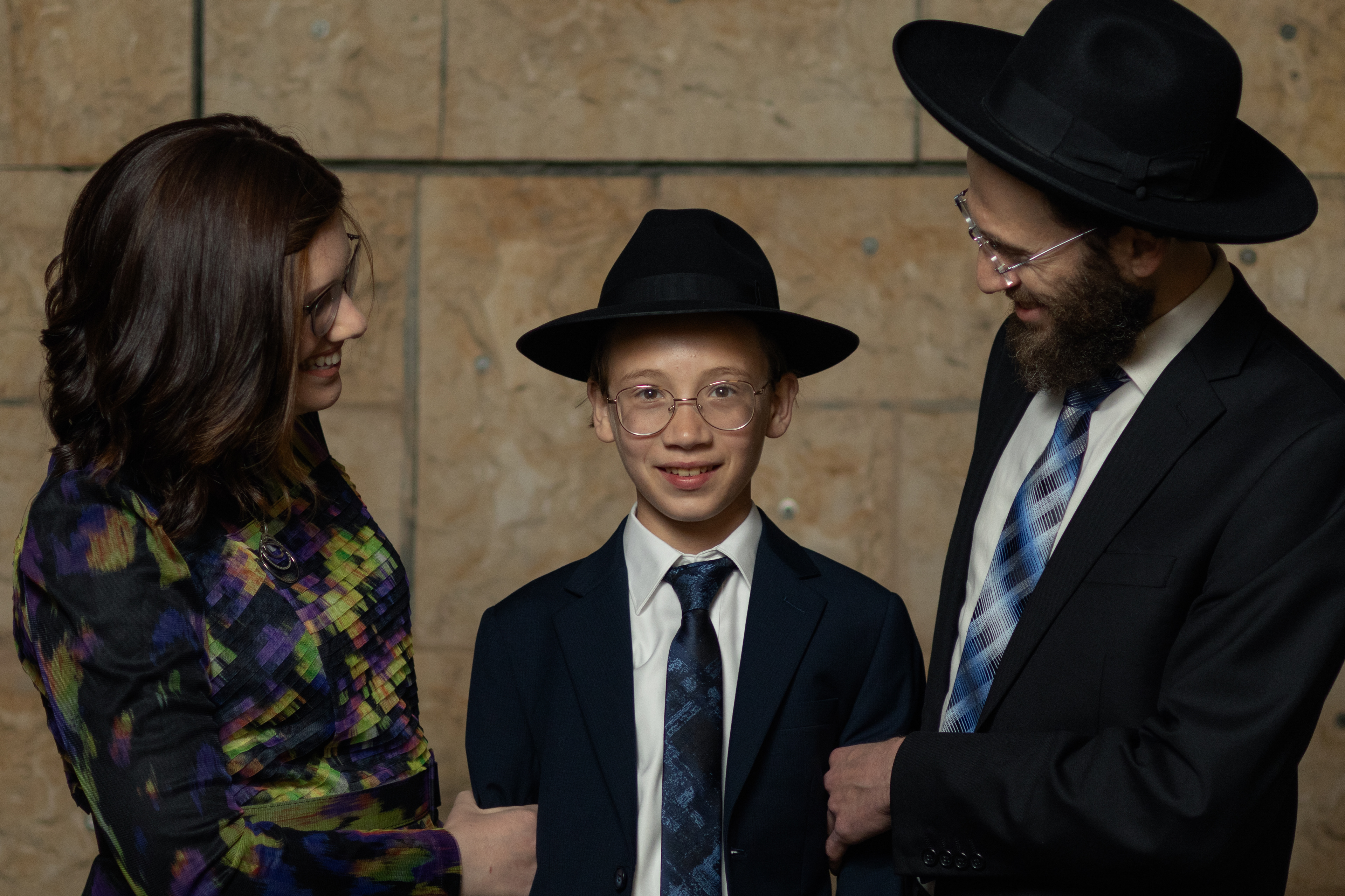 boy with parents smiling