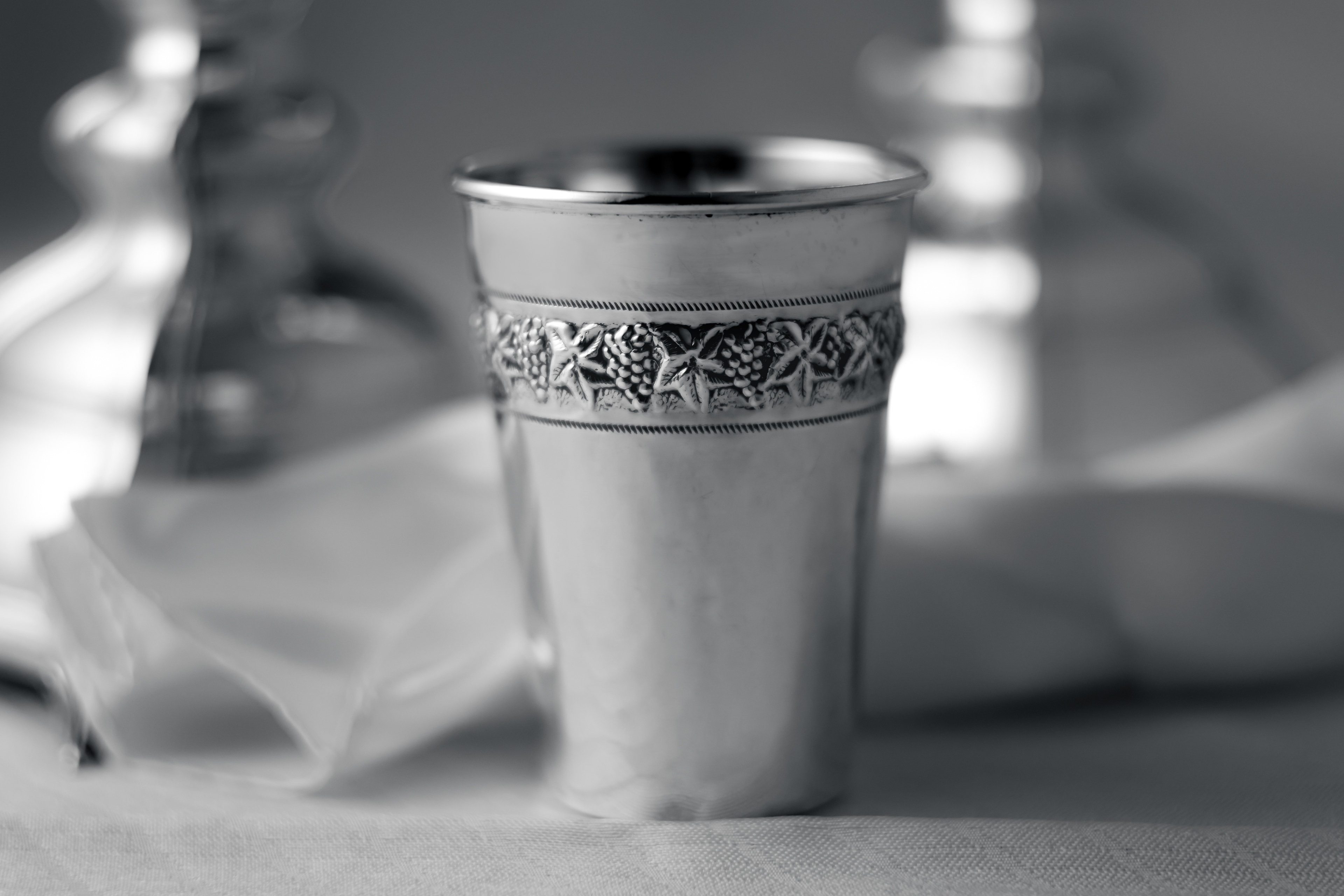 closeup of silver cup showing detail in design