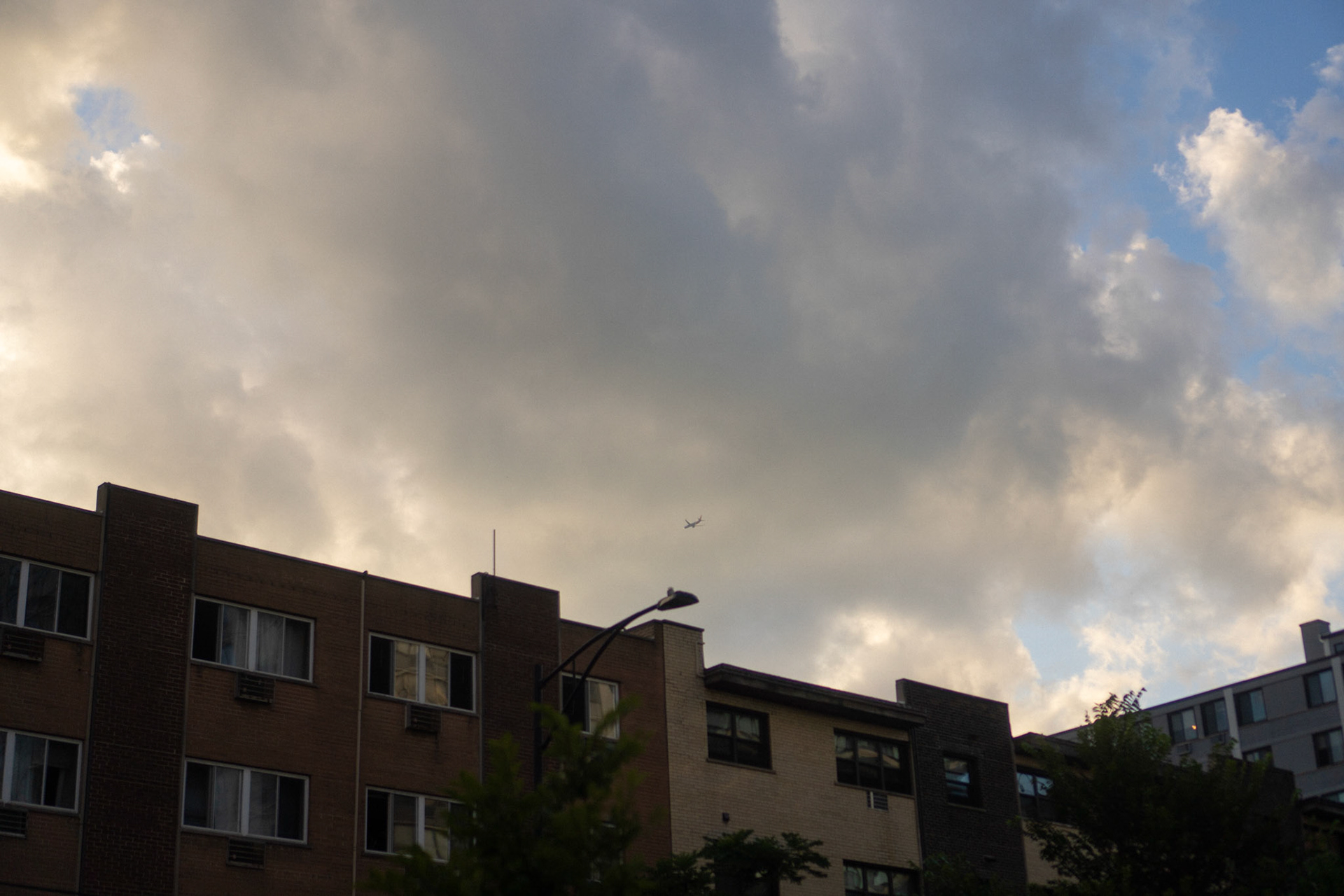 rich fluffy full clouds contrasting with the apartment's sharp lines
