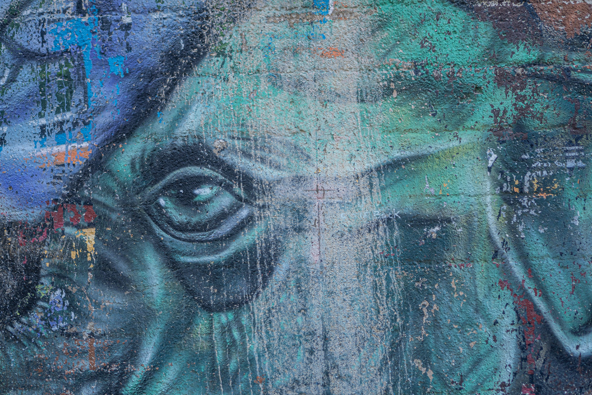 Eyes peering back from the alleyway graffiti.