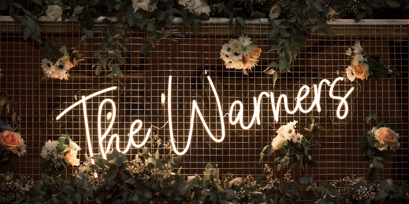 the warners neon sign for a boho nature wedding at a country estate in pretoria photographed by black rock studio